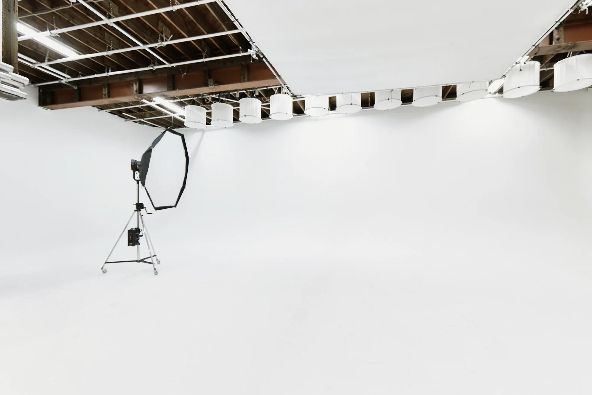 Wide view of the Sterling Studio Toronto soundstage floor showing a high-output Aputure Electro Storm fixture for scale on the cyclorama wall.