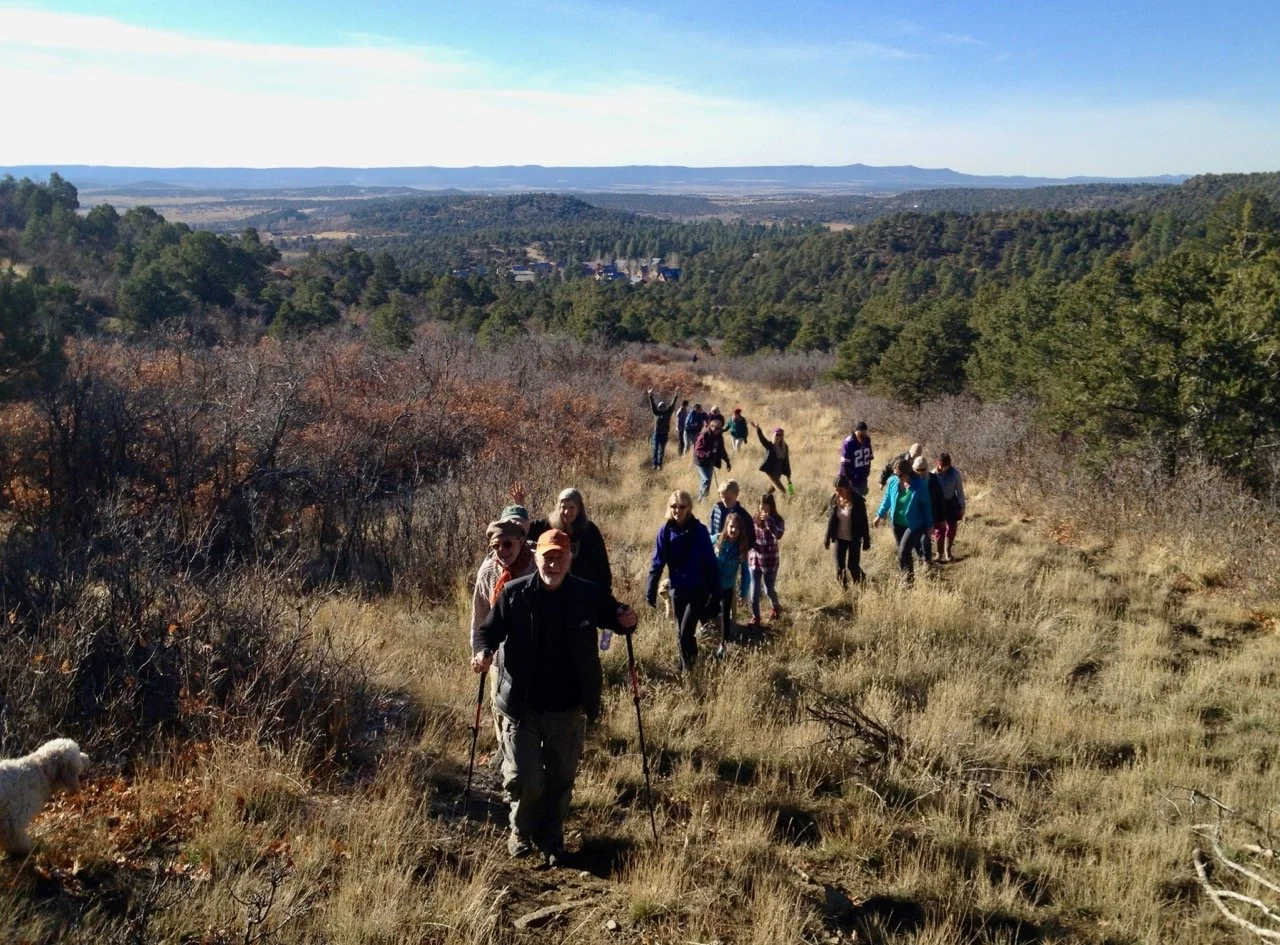 Our annual Turkey Trot hike on one of the trails in the north portion of our property, with the housing cluster visible in the background.
