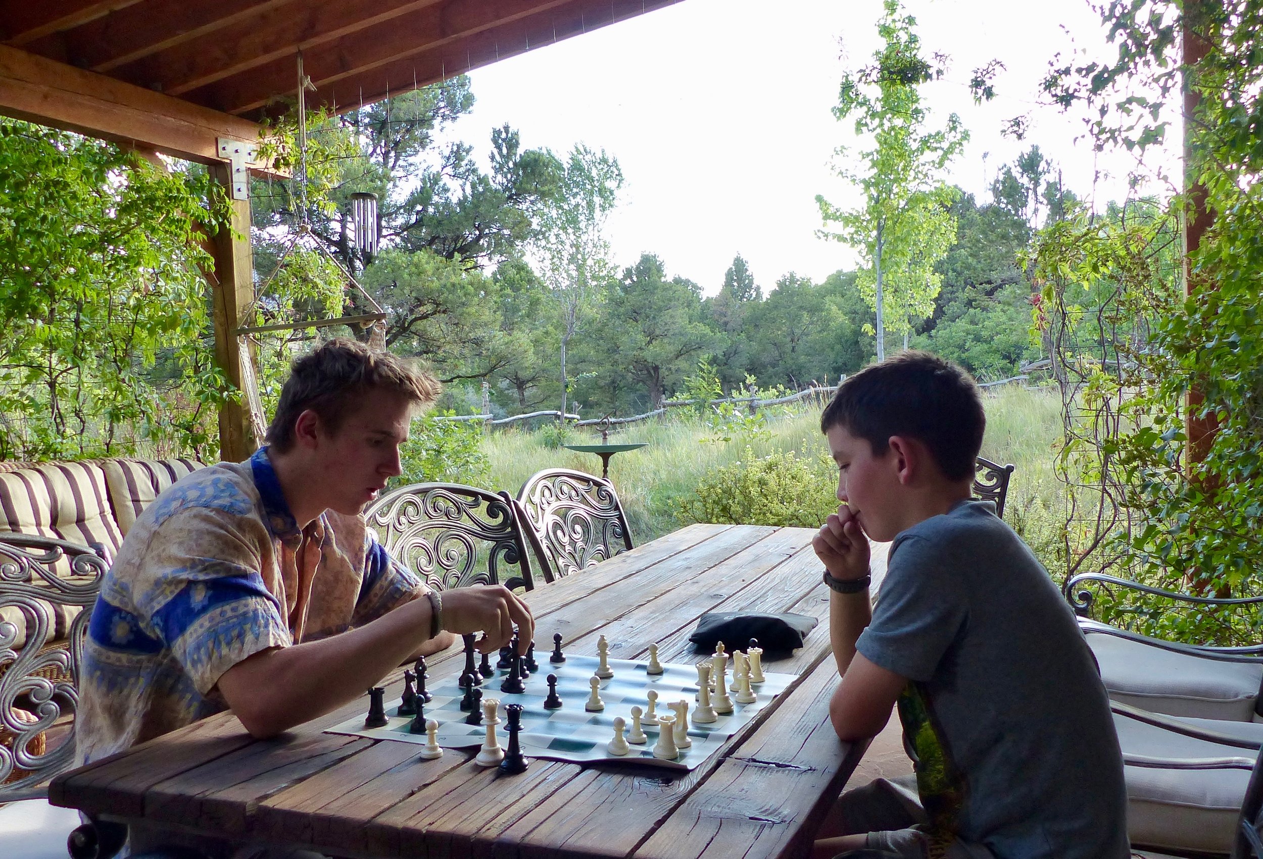 Playing chess on a backyard patio.