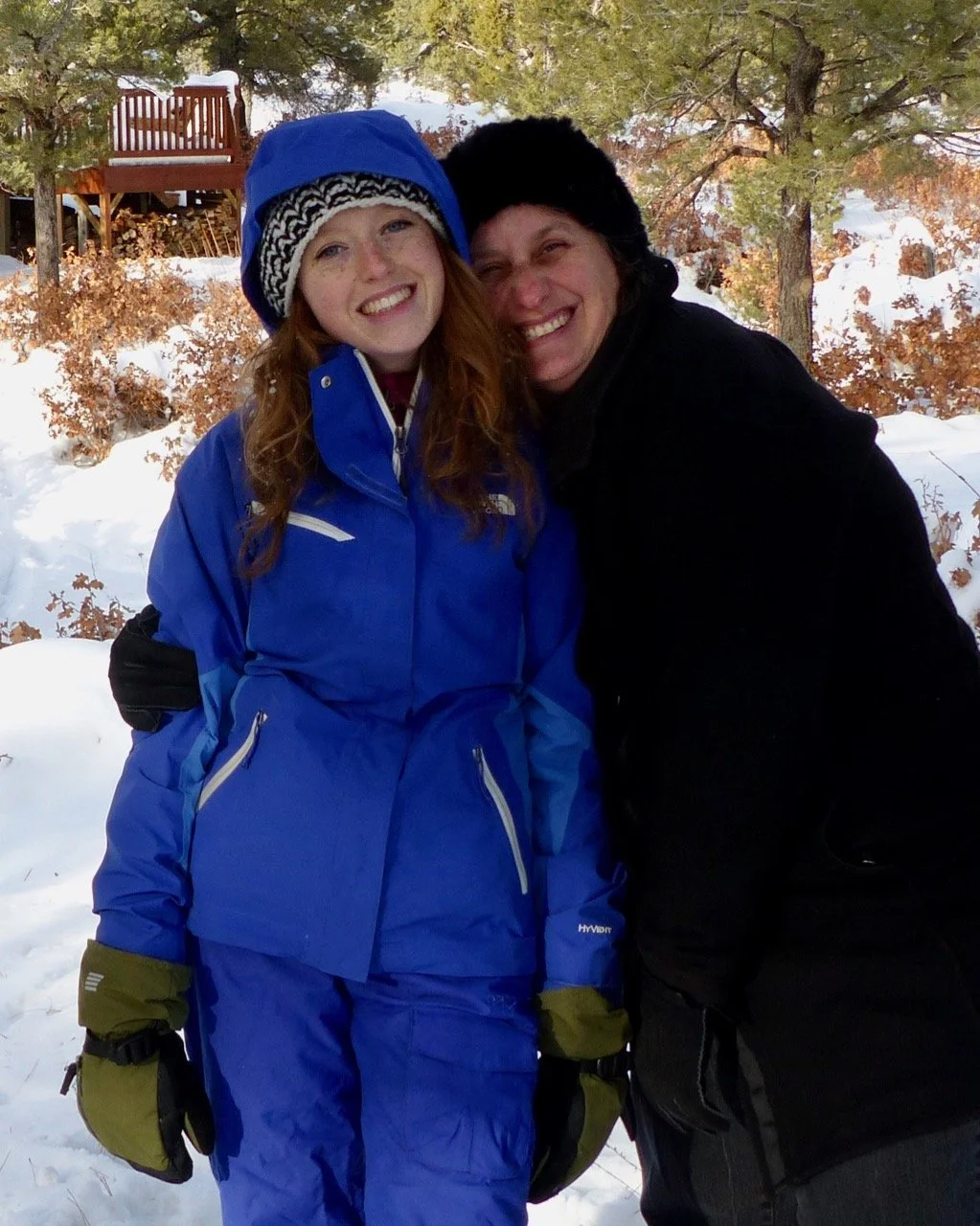 Mother-daughter love at the sledding hill.