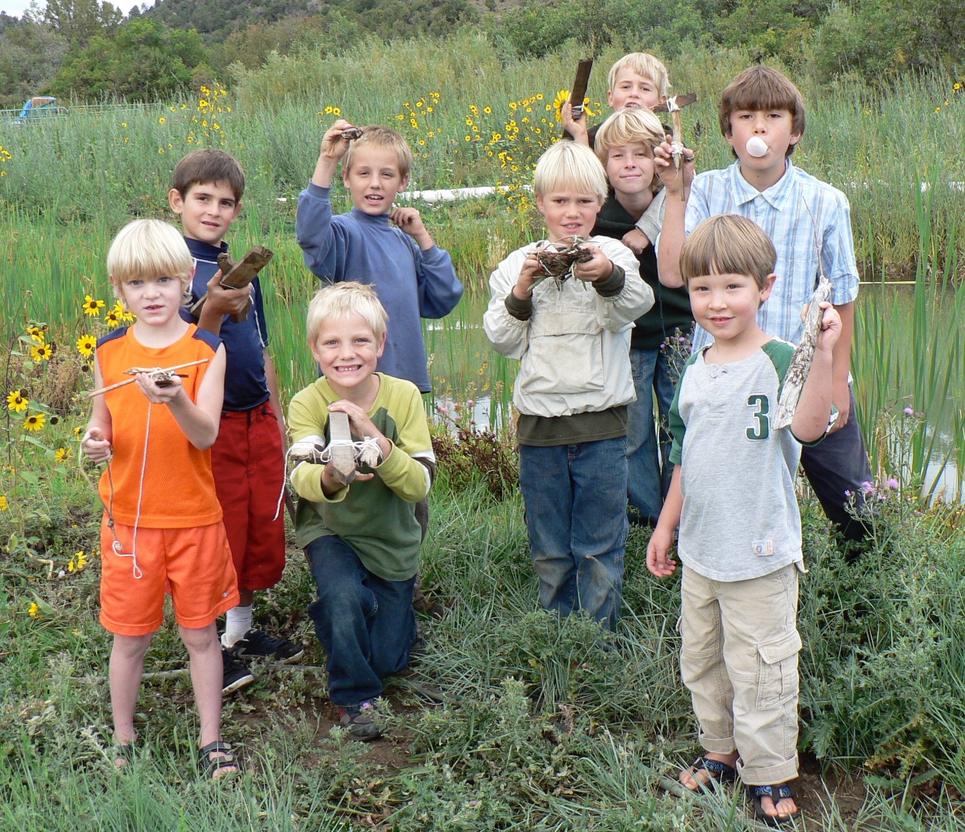 Boys making stick boats at the middle pond.