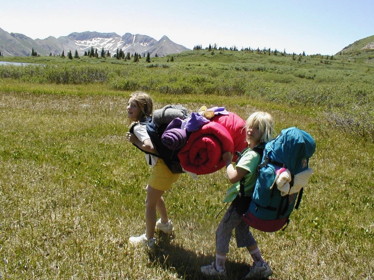 Helen helping Gracie with her not-so-well-balanced pack on a girls backpack trip.