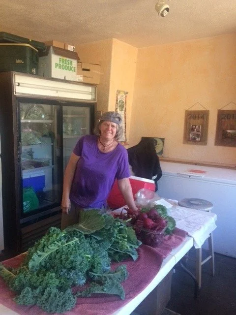 Sandy at the common house with freshly harvested produce.