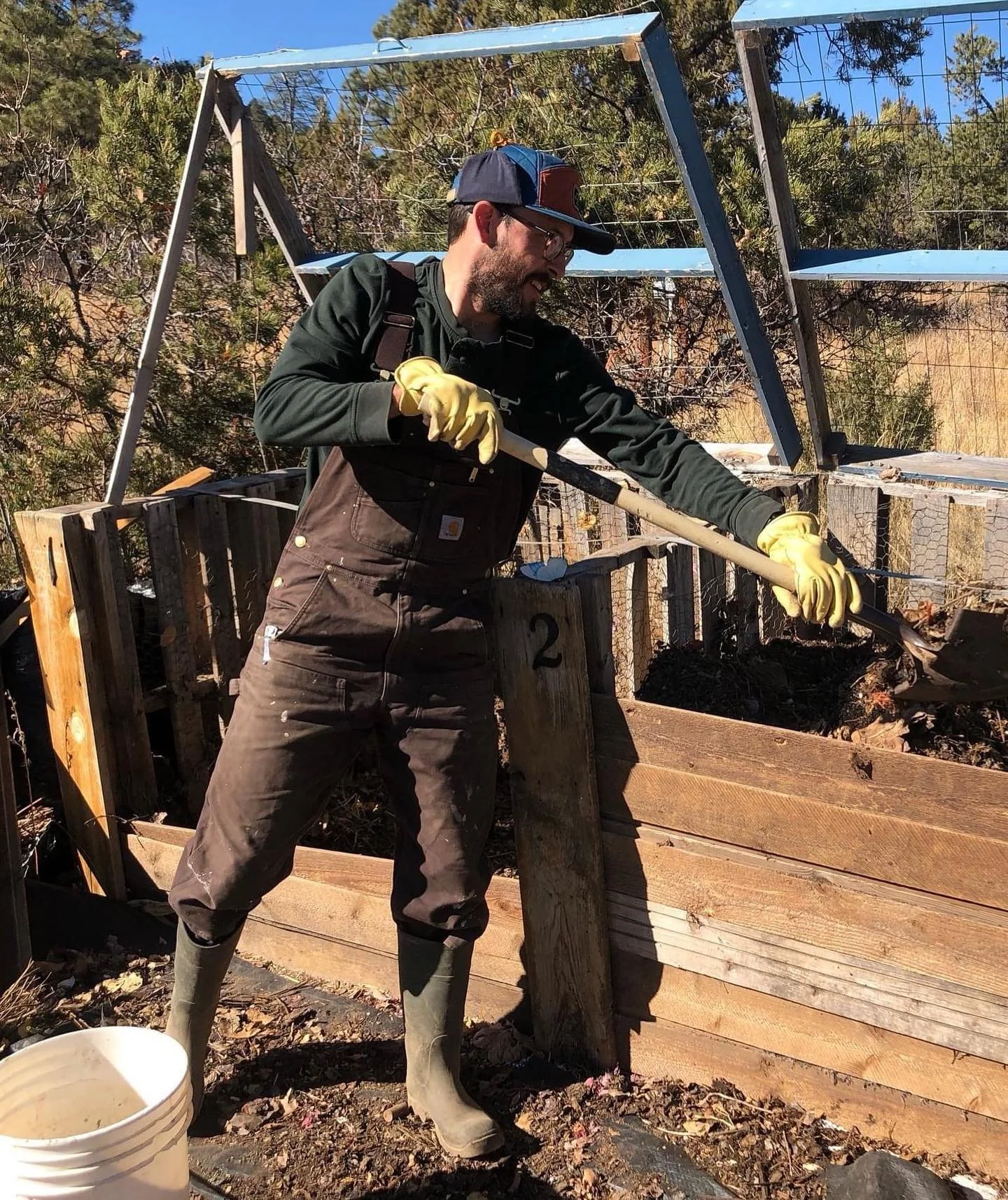 Dylan turning the compost.
