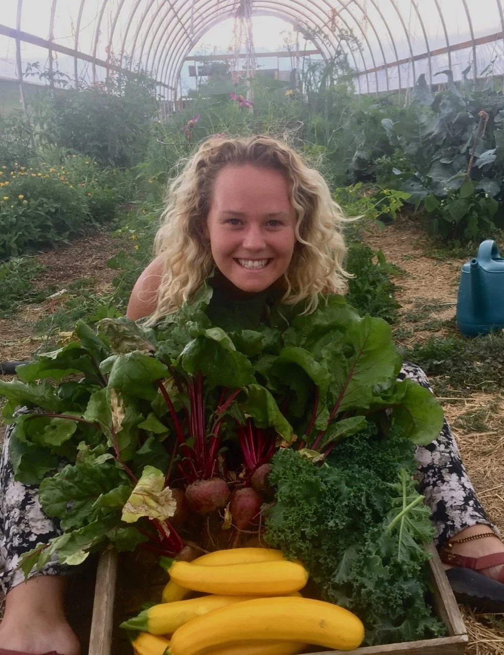 Sarah, pretty darn happy with fresh harvest from the high tunnel.
