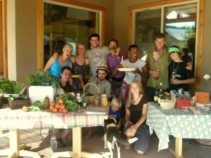 Farm interns hosting a farmers market at the common house