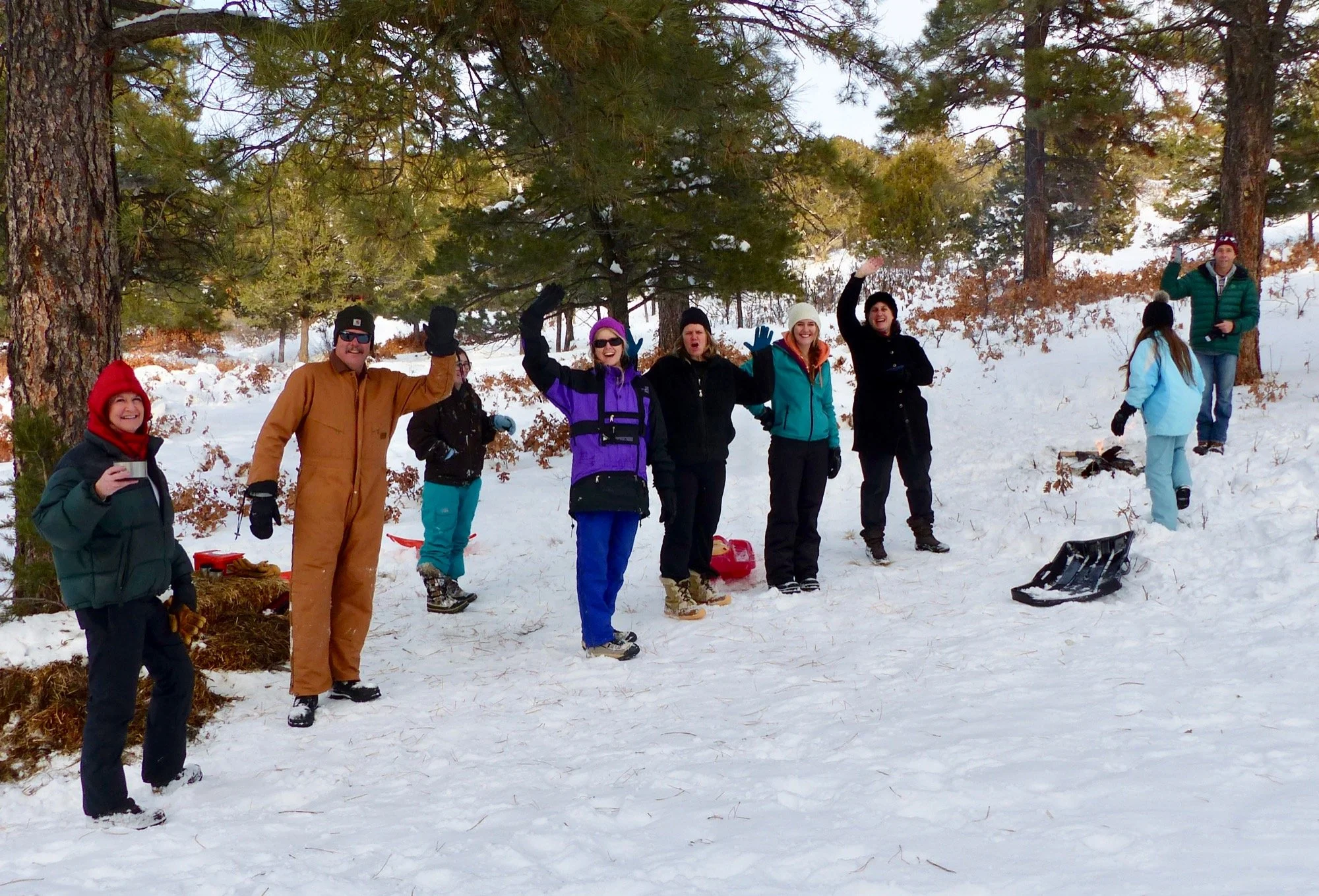 Drinking hot chocolate at a sledding party.
