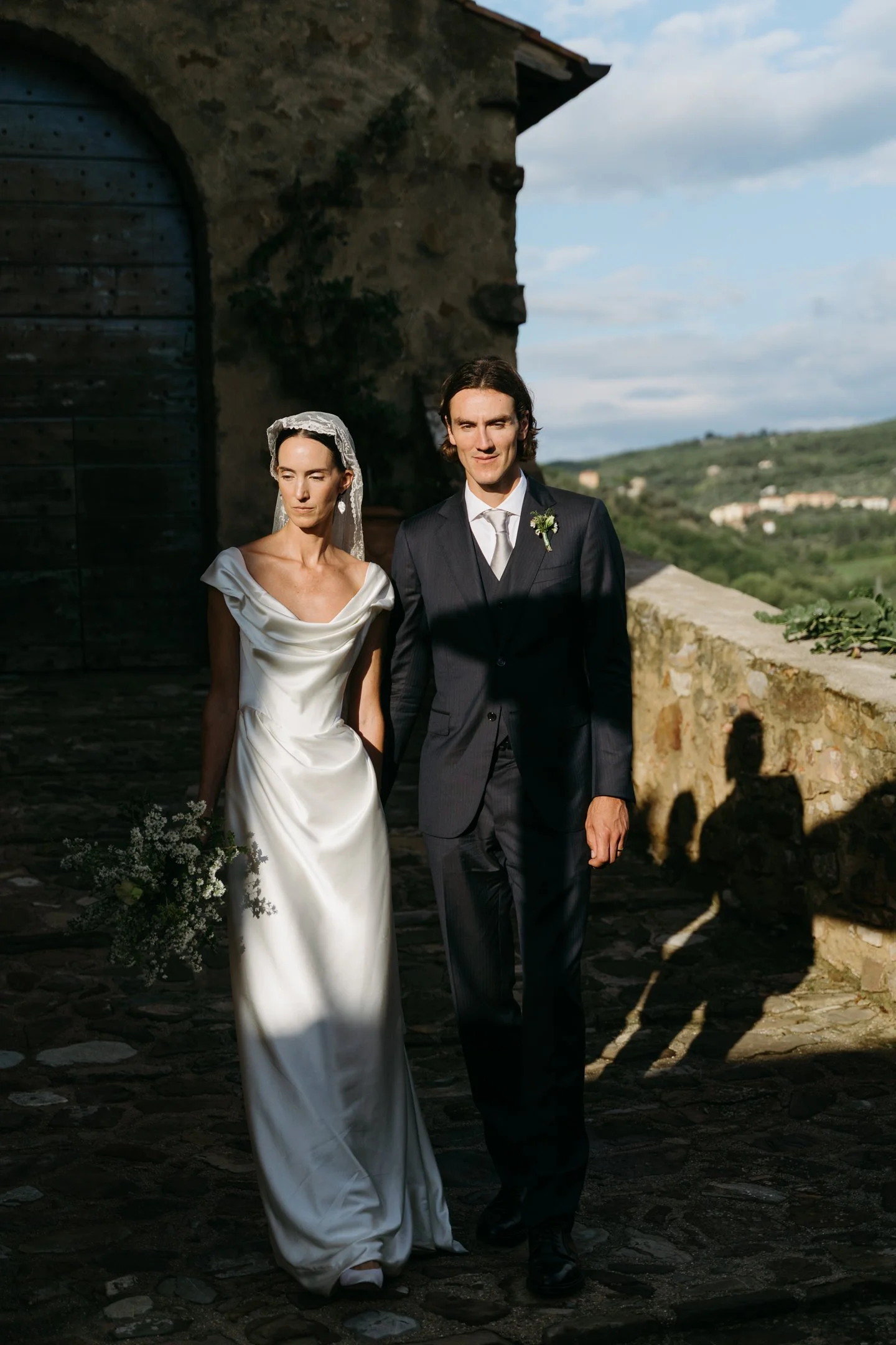 bride and groom walking at Castello di Potentino Tuscany wedding