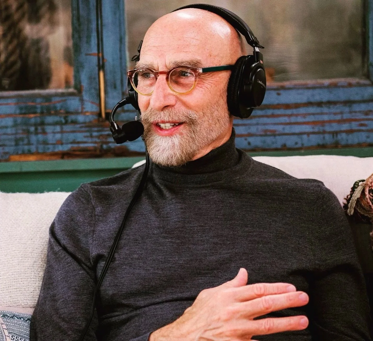 David E Moreno wearing headphones and a microphone on the Beyond the Fog Radio Podcast
