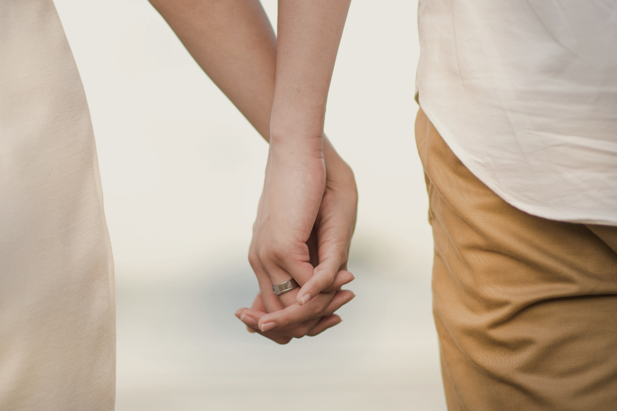 married couple holding hands
