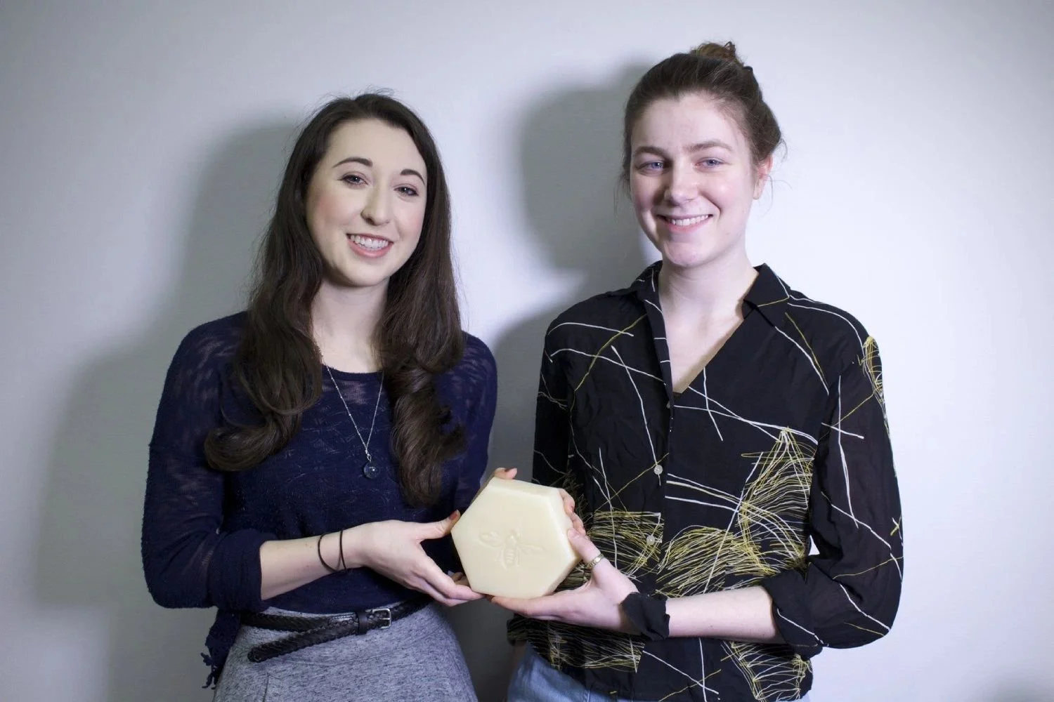 FIT Hives Co-Founders Sarah Langenbach and Shona Neary with a honeycomb made of beeswax