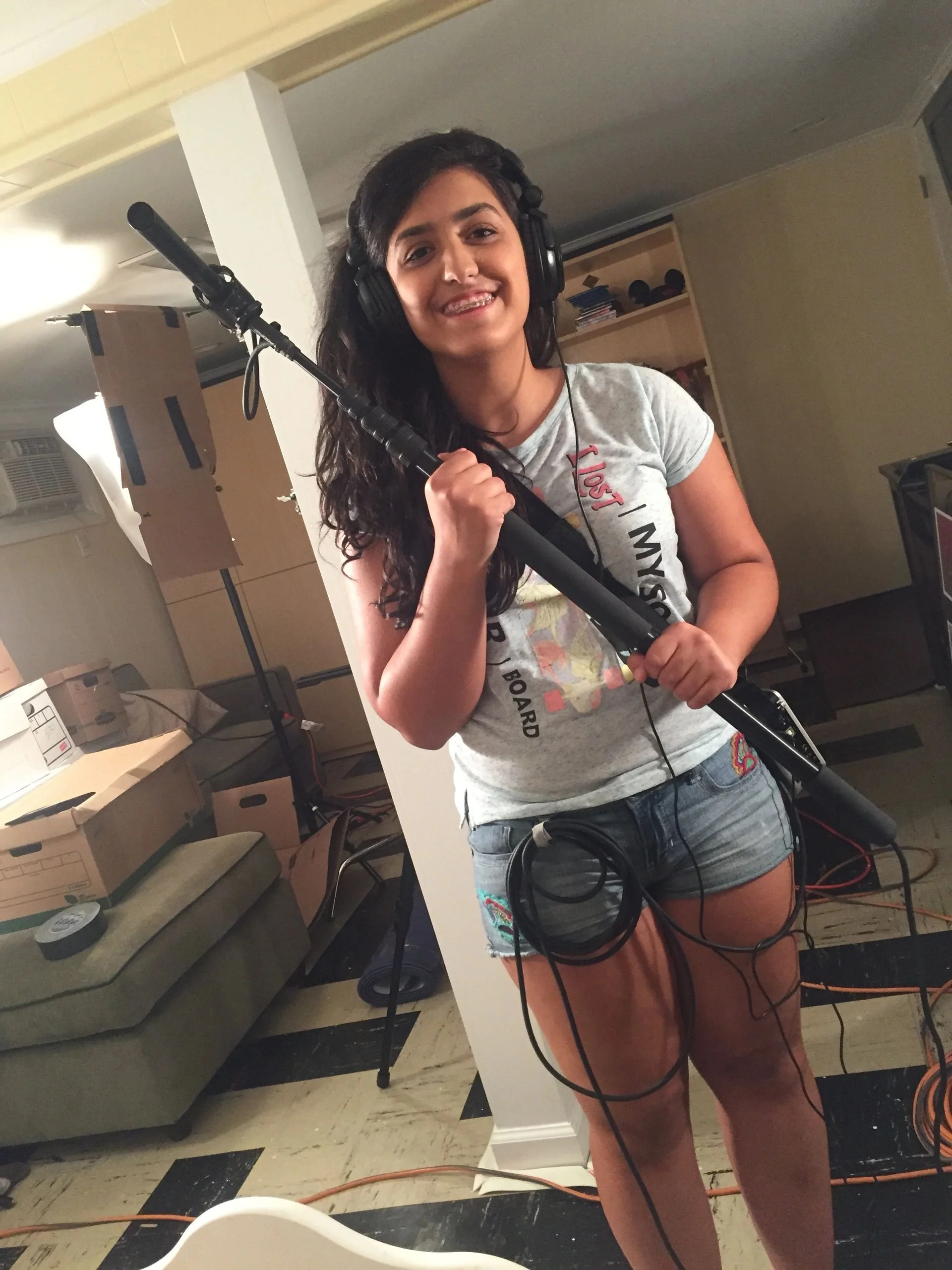 Katerina Tzaras on set doing boom microphone.