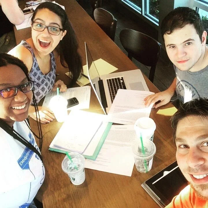 Max Hechtman, Alana Reilly, Michelle Williams and Christonikos Tsalikis holding a story meeting.