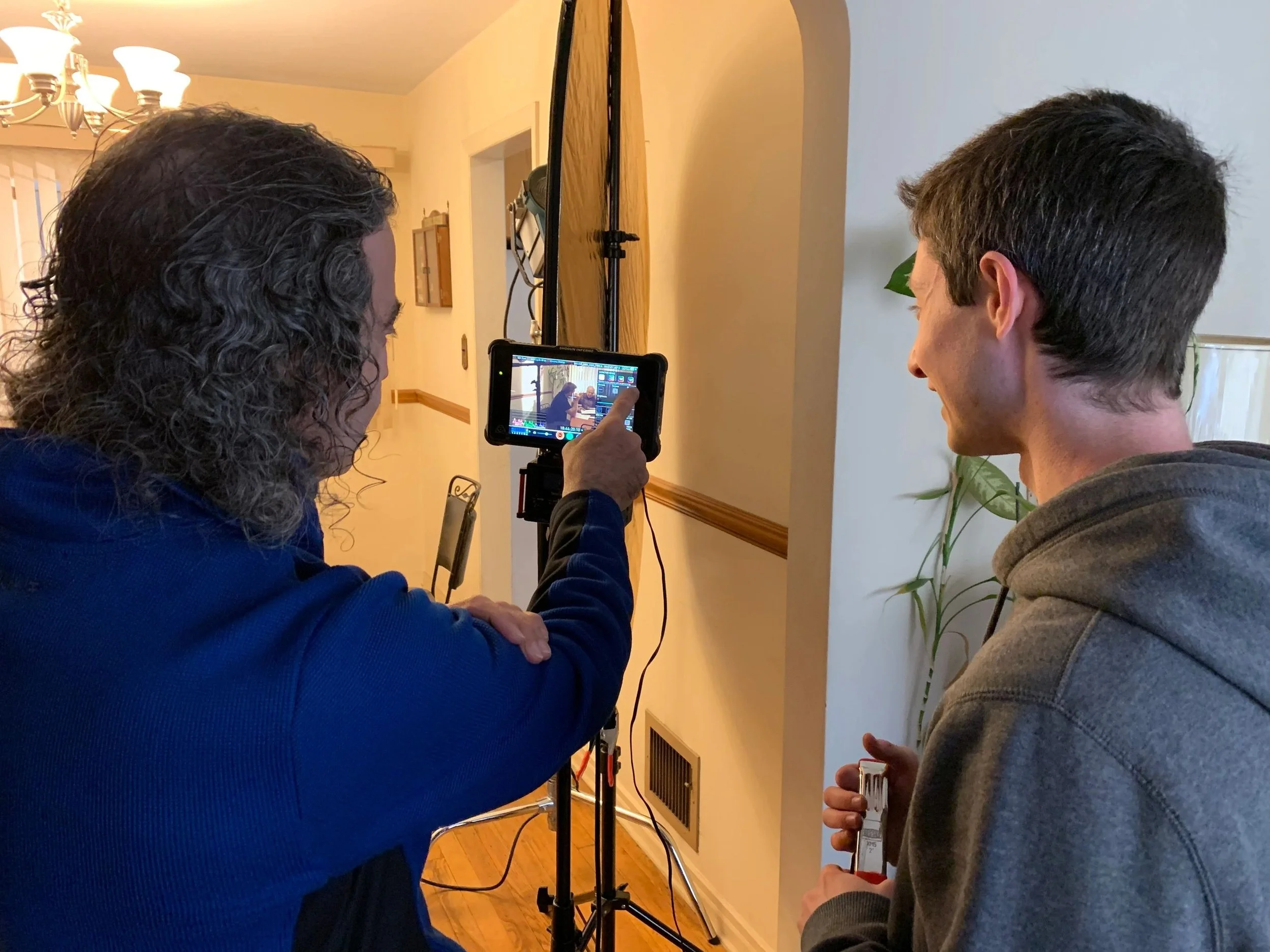 Co-director of photography Joe Daniele mentors script supervisor Nathan Siegelaub on set.