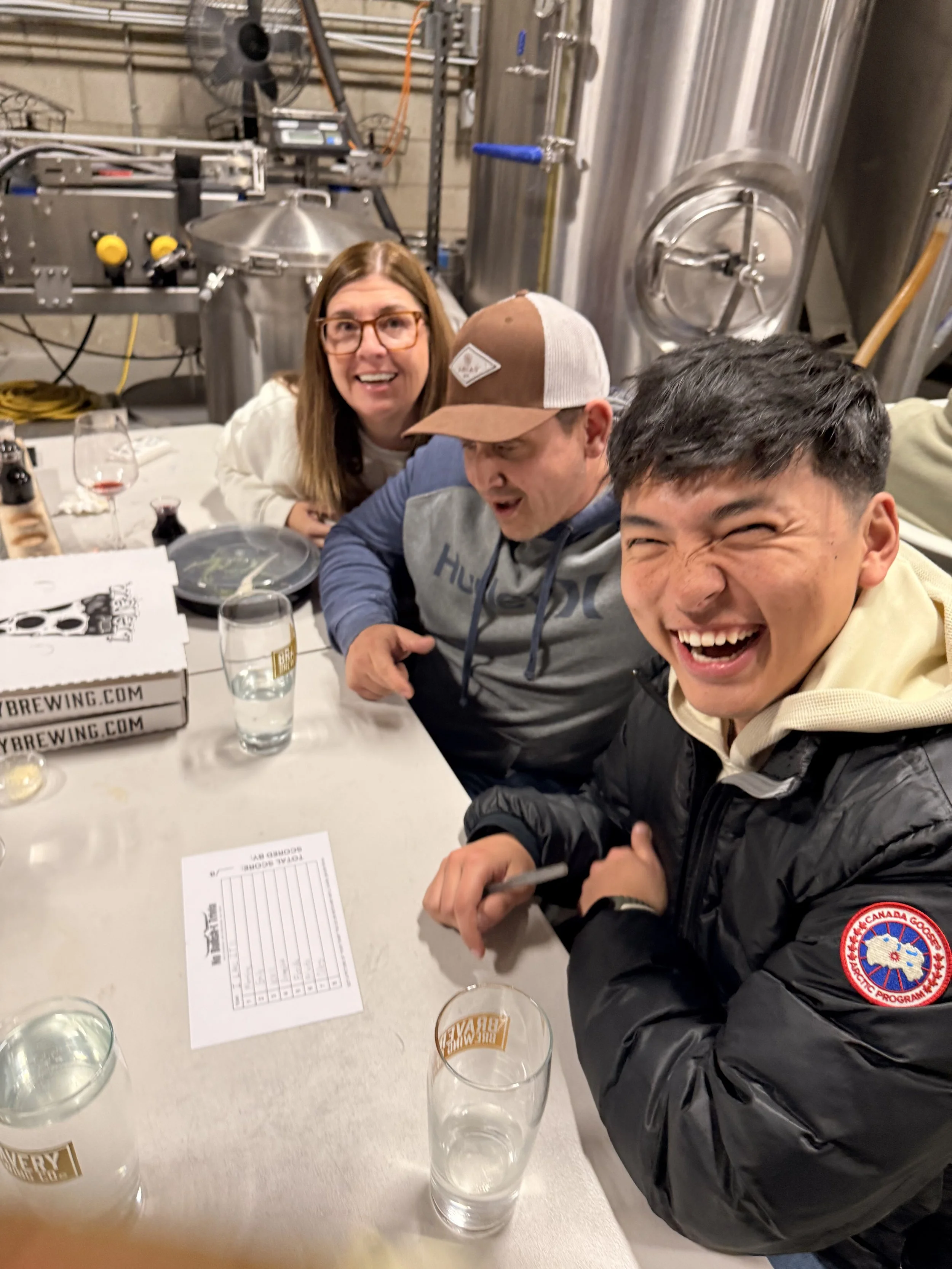 A photograph of a team playing No Bullshit trivia and laughing