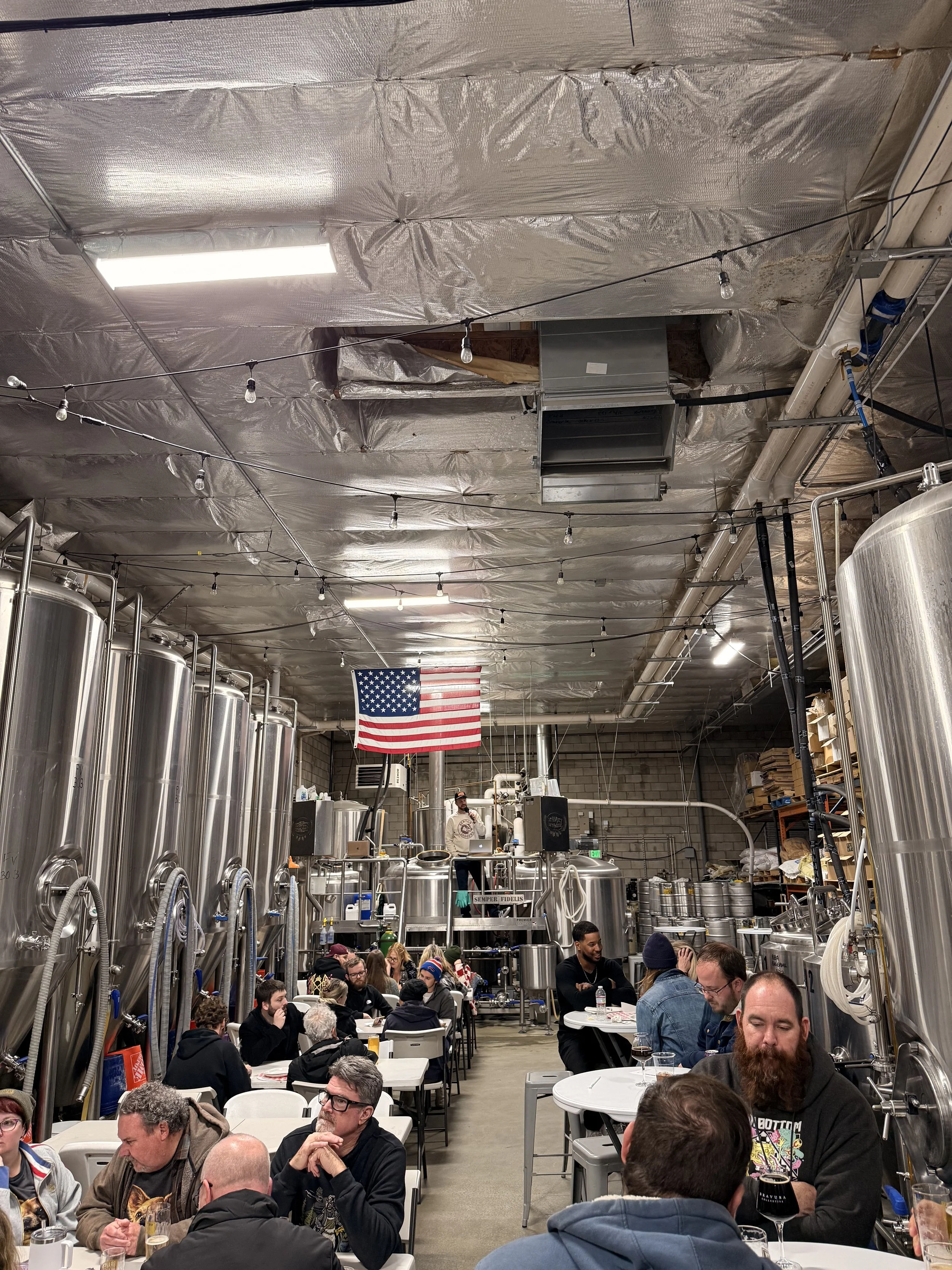 A photograph of a crowded brew room filled with teams playing No Bullshit Trivia