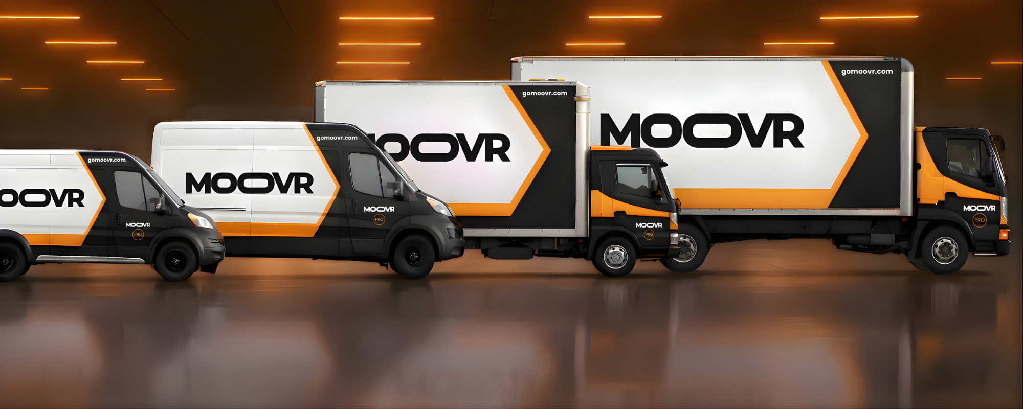 Three delivery trucks with the MOOVR logo and branding, parked indoors with a dark background and orange lighting.