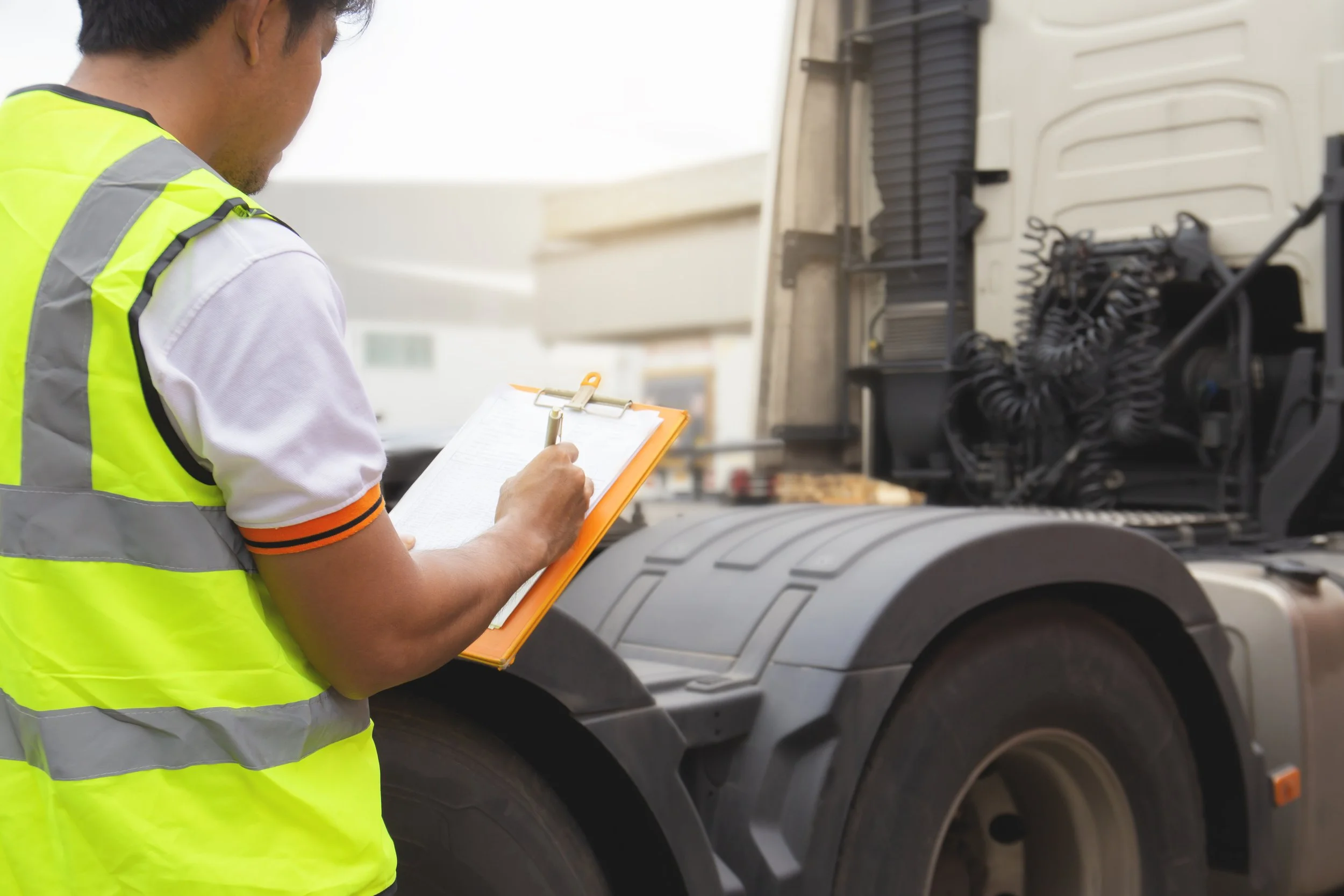 truck-driver-inspecting-safety-daily-checklist-semi-truck.jpg
