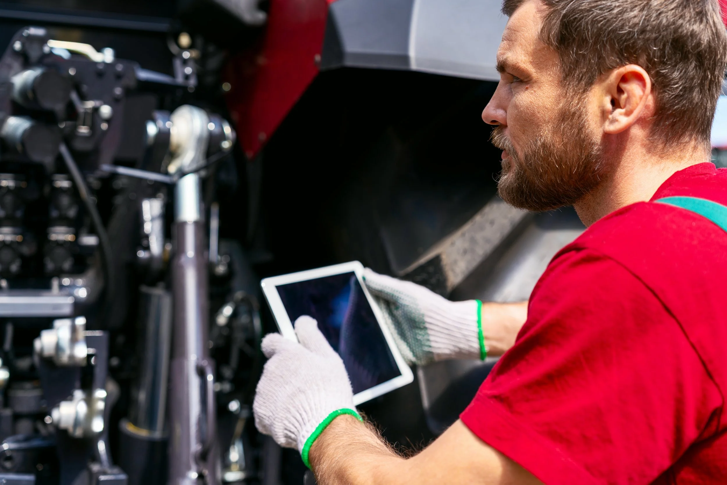 equipment technician inspecting vehicle