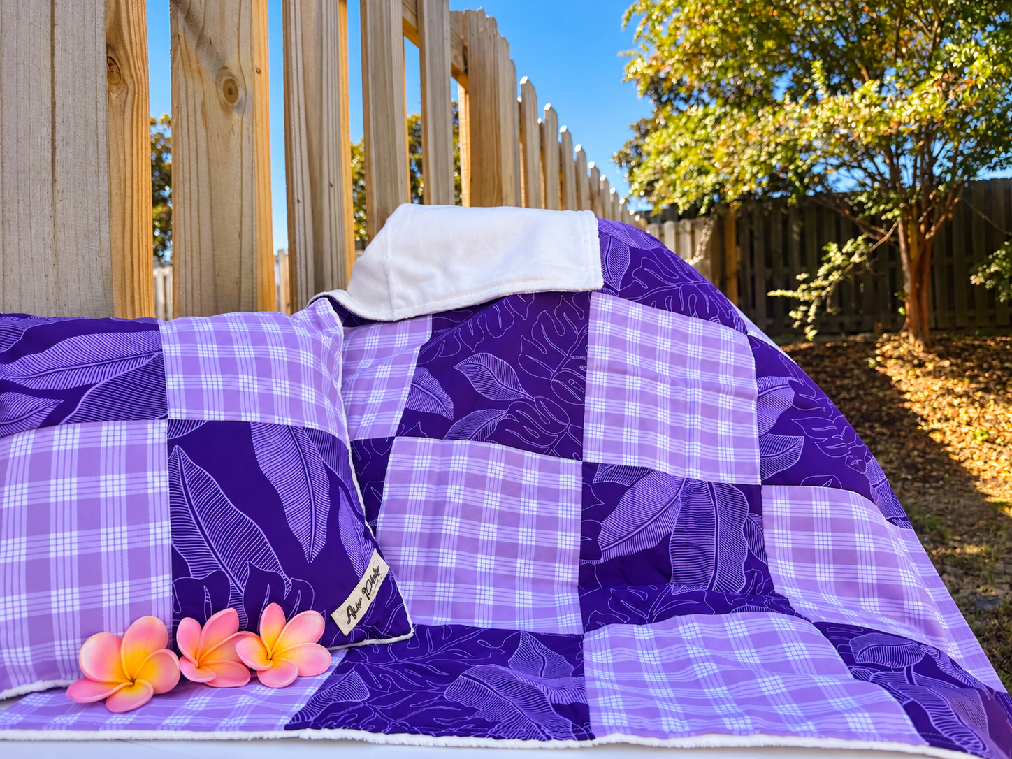 Purple Patchwork Quilt in a Sunny Backyard.png
