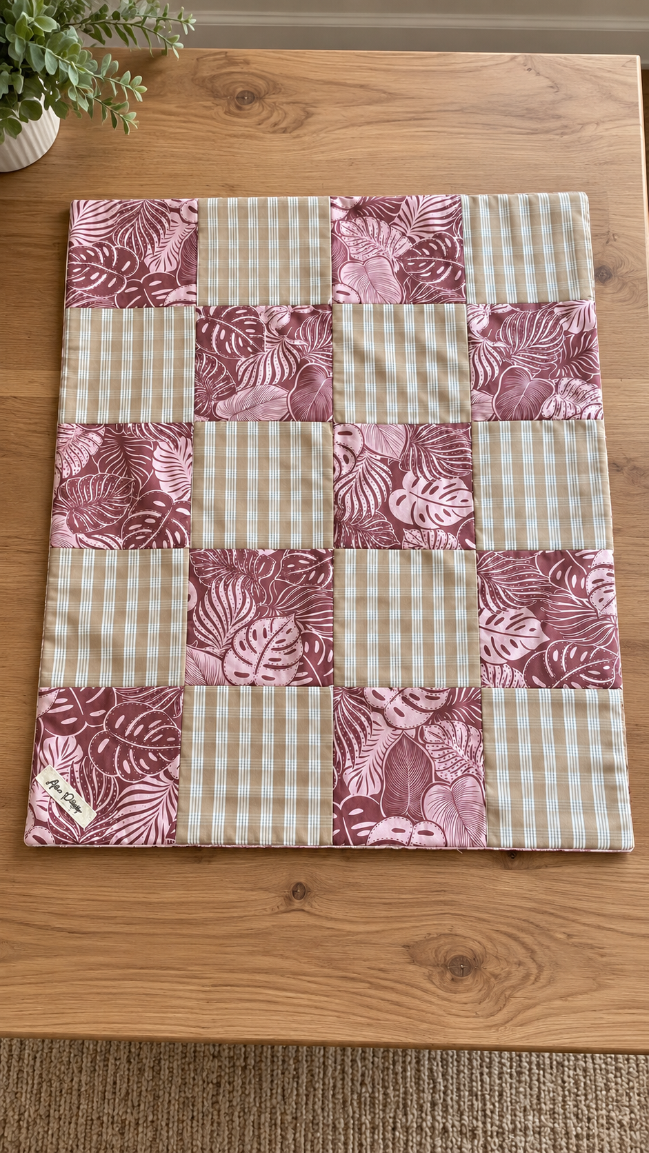 Mauve Botanical Patchwork Quilt on Wood.png