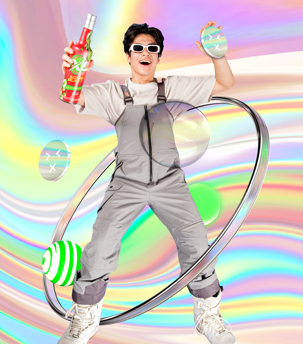 Person wearing white sunglasses, holding a bottle of colorful beverage, dancing on a surreal, rainbow-colored background with floating orbs and a metallic ring.