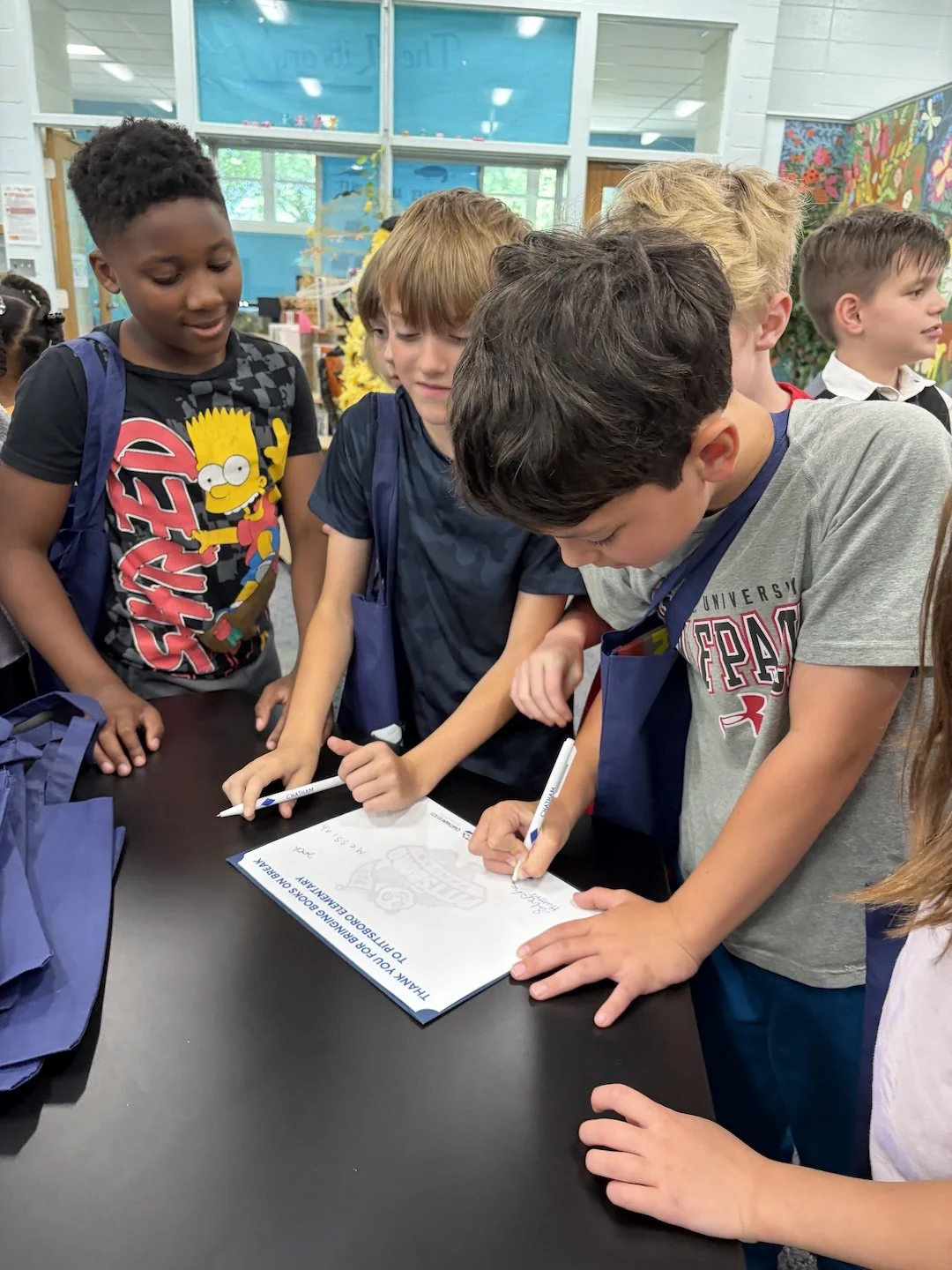 Pittsboro students sign a card for Peggy Myers