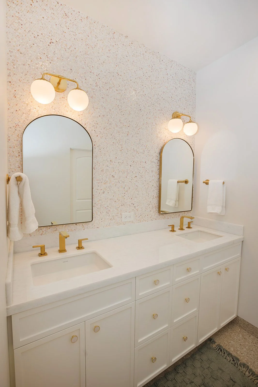 New bathroom with bright lighting, and white granite countertops in Santa Barbara