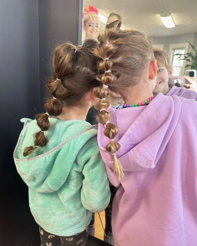 Braided hairstyle details shown during a salon event.