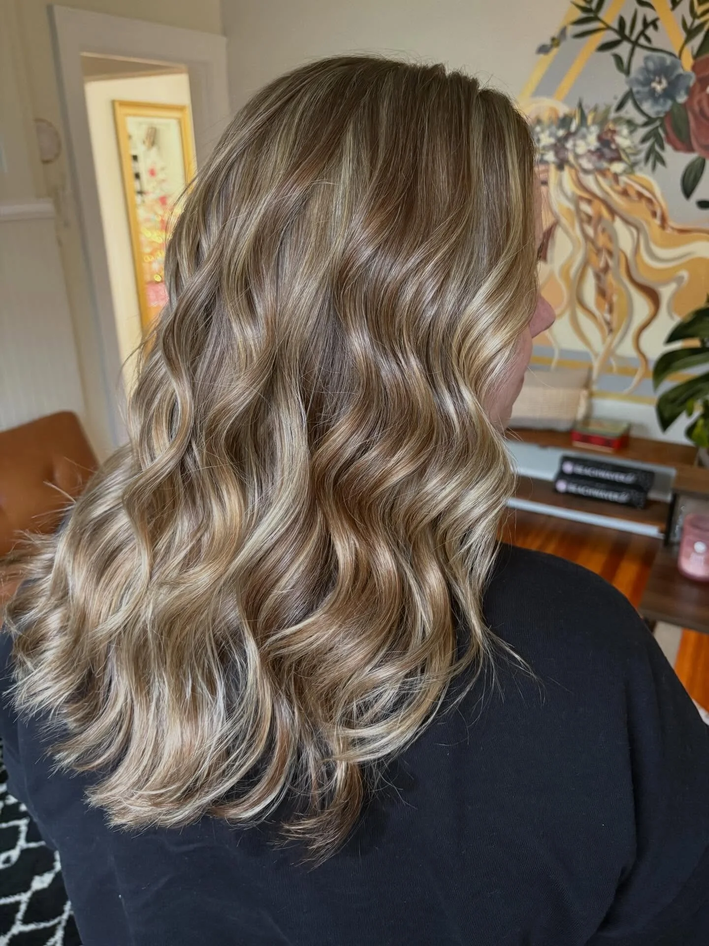 Back view of warm brunette hair with soft, dimensional waves and blended highlights.