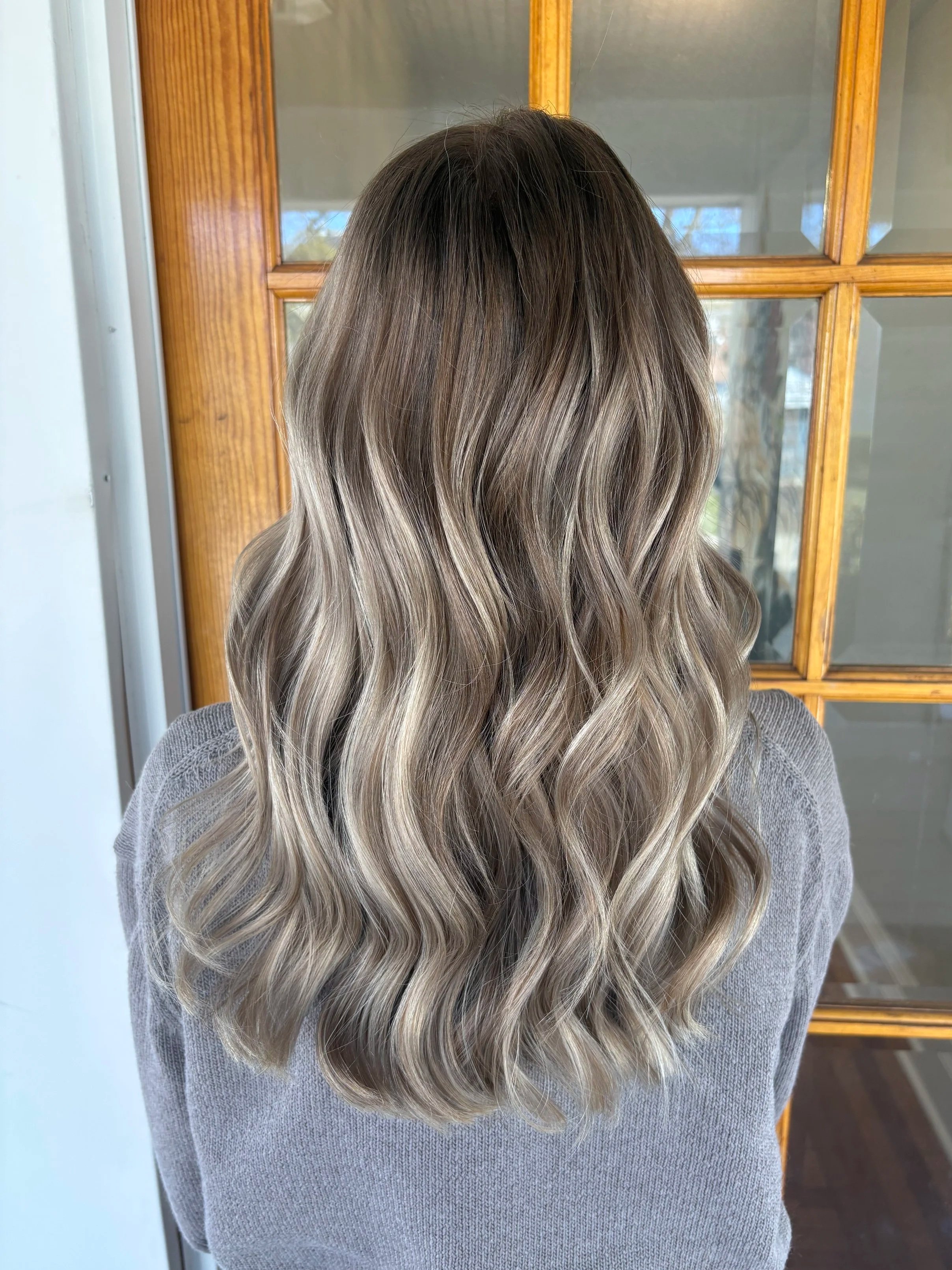 Close-up of soft, lived-in blonde waves styled with a natural finish.