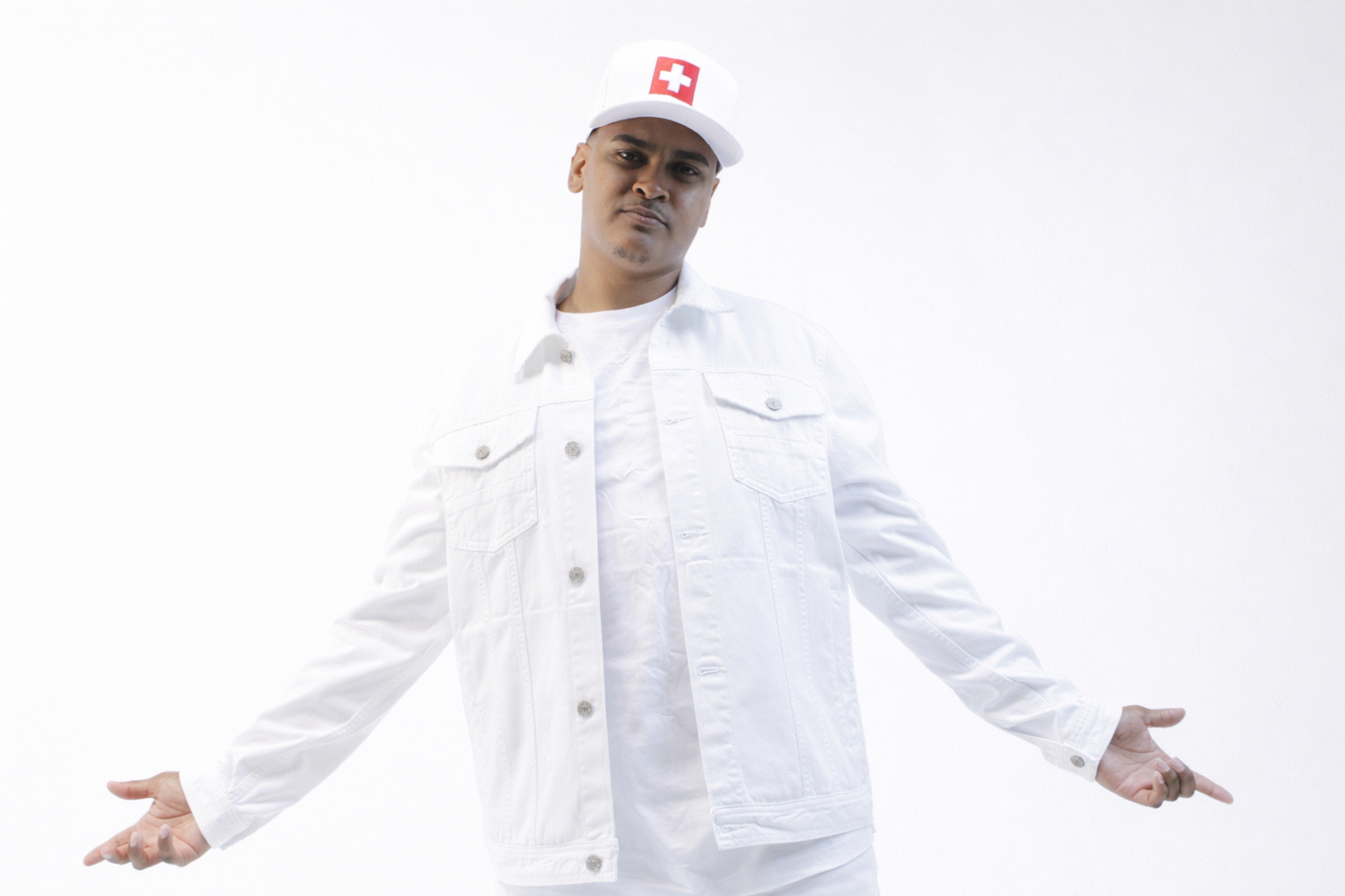 Studio portrait of CV$H in a white denim jacket and matching cap against a light background