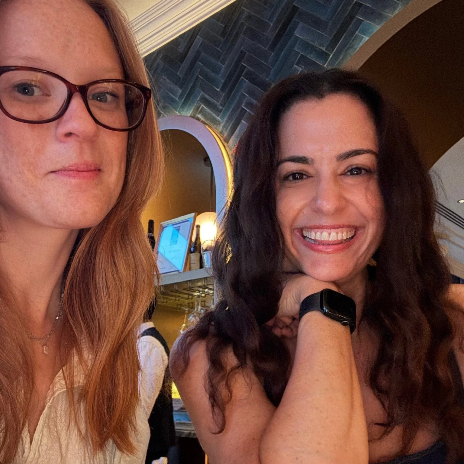 Two neurodivergent women entrepreneurs taking a selfie, smiling and looking at the camera.