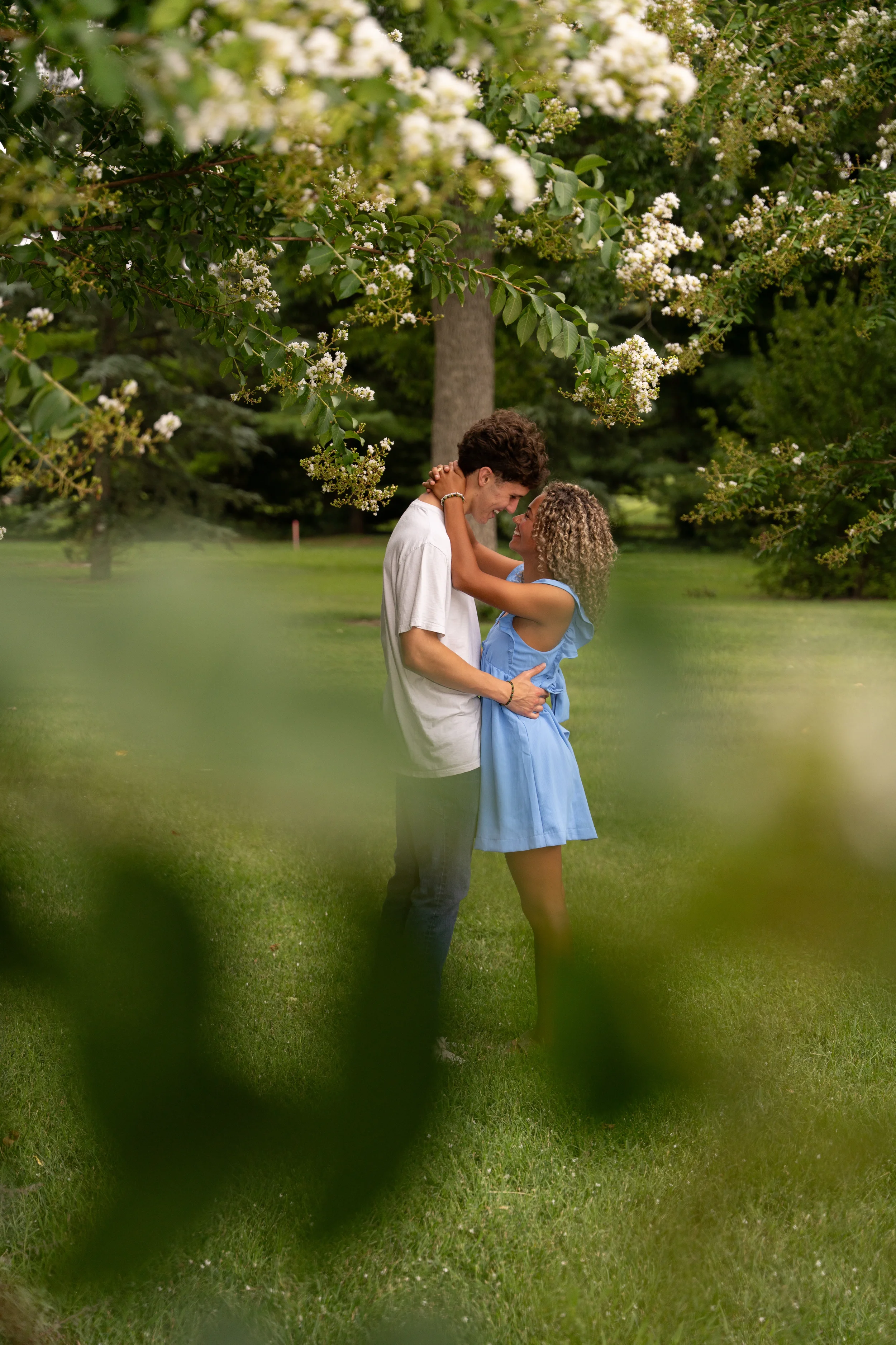 Couples photo in park with foreground element