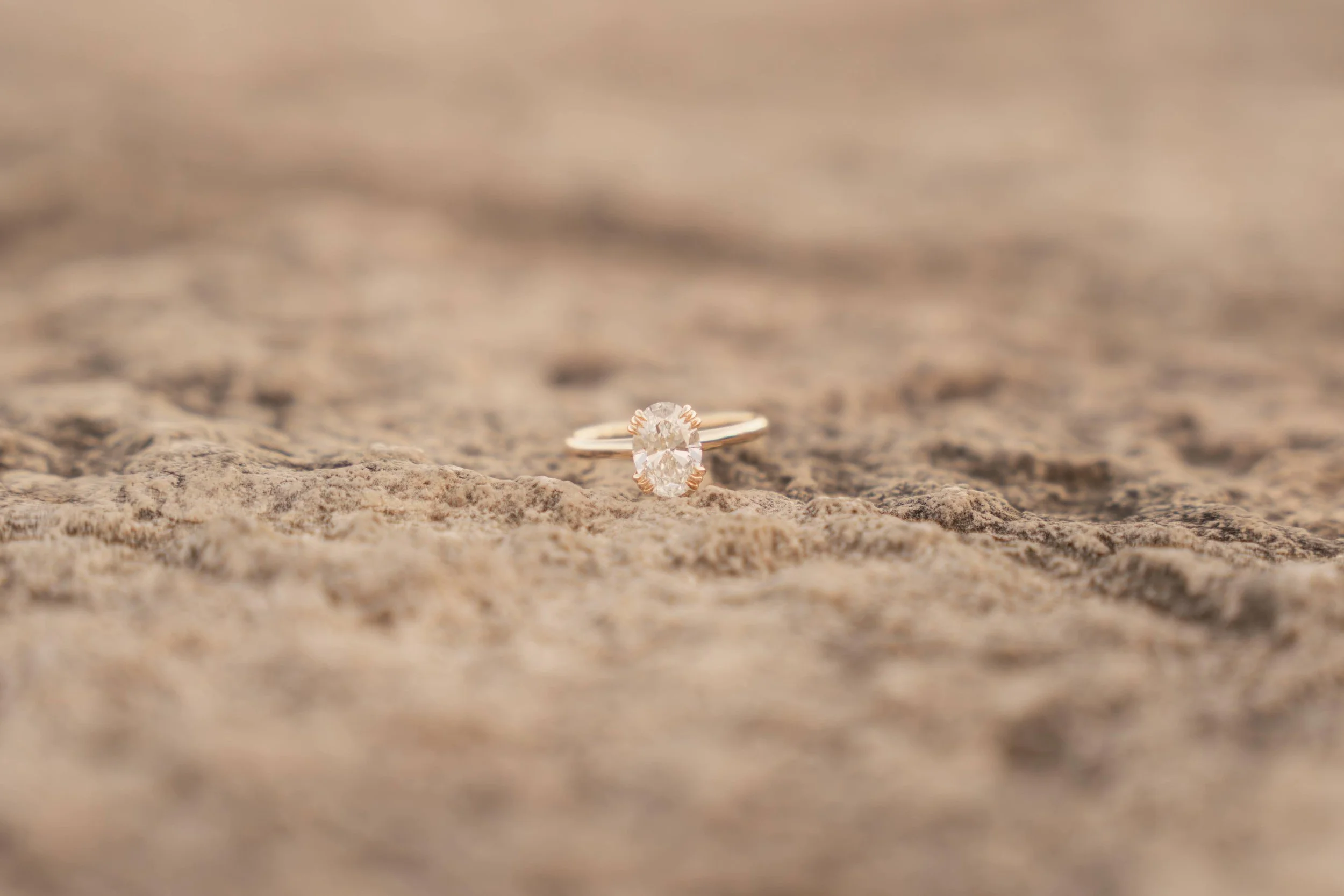 Engagement ring detail shot in the sand