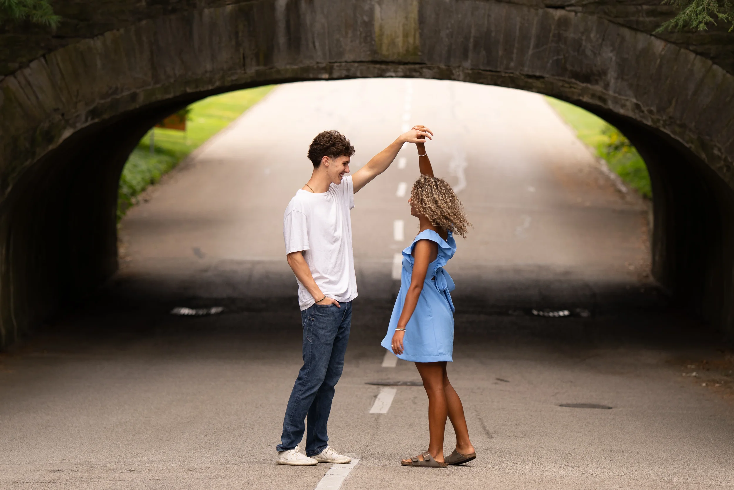 Couples photo dancing under a bridge