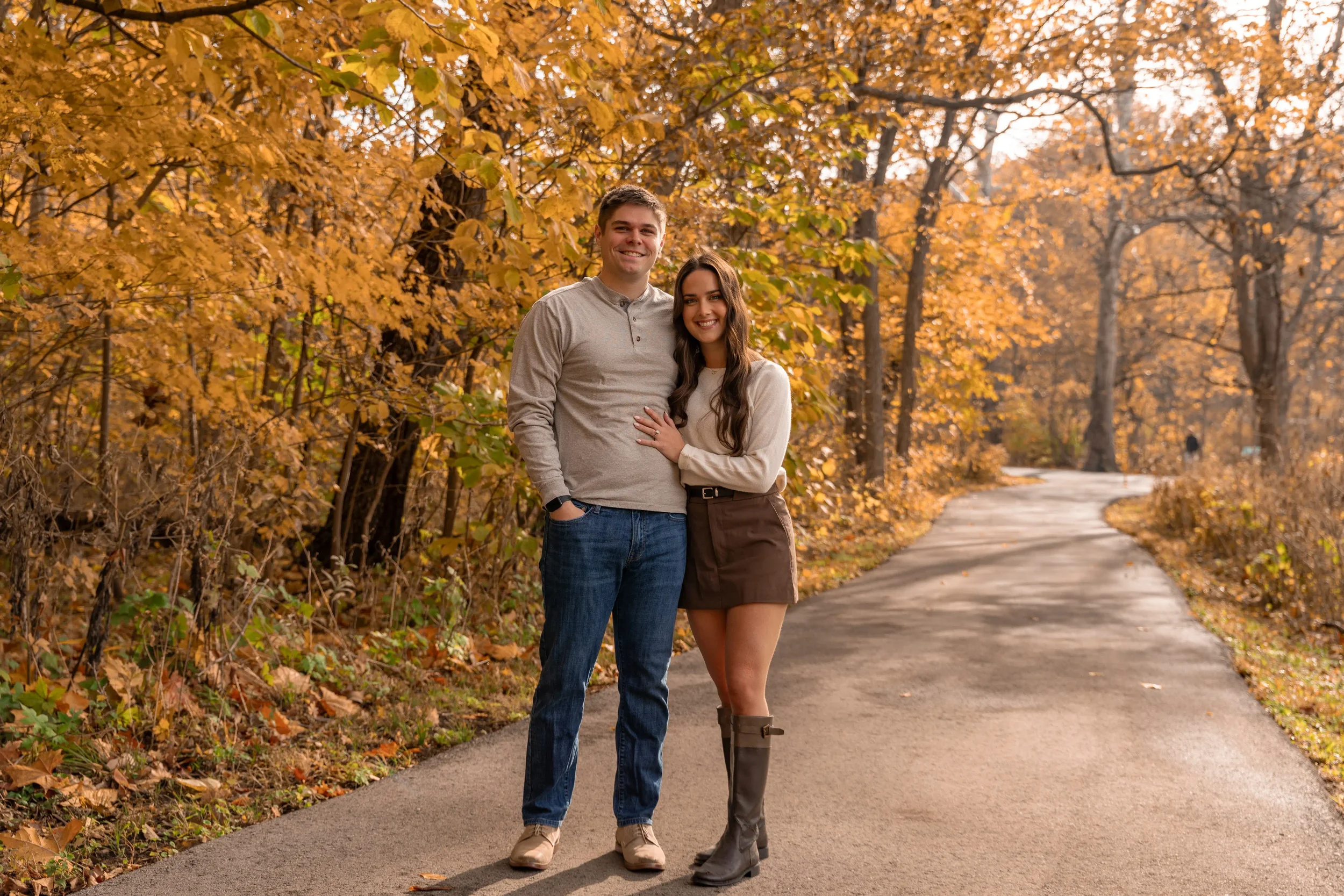 Fiance smiling with Fiancee in wooded park