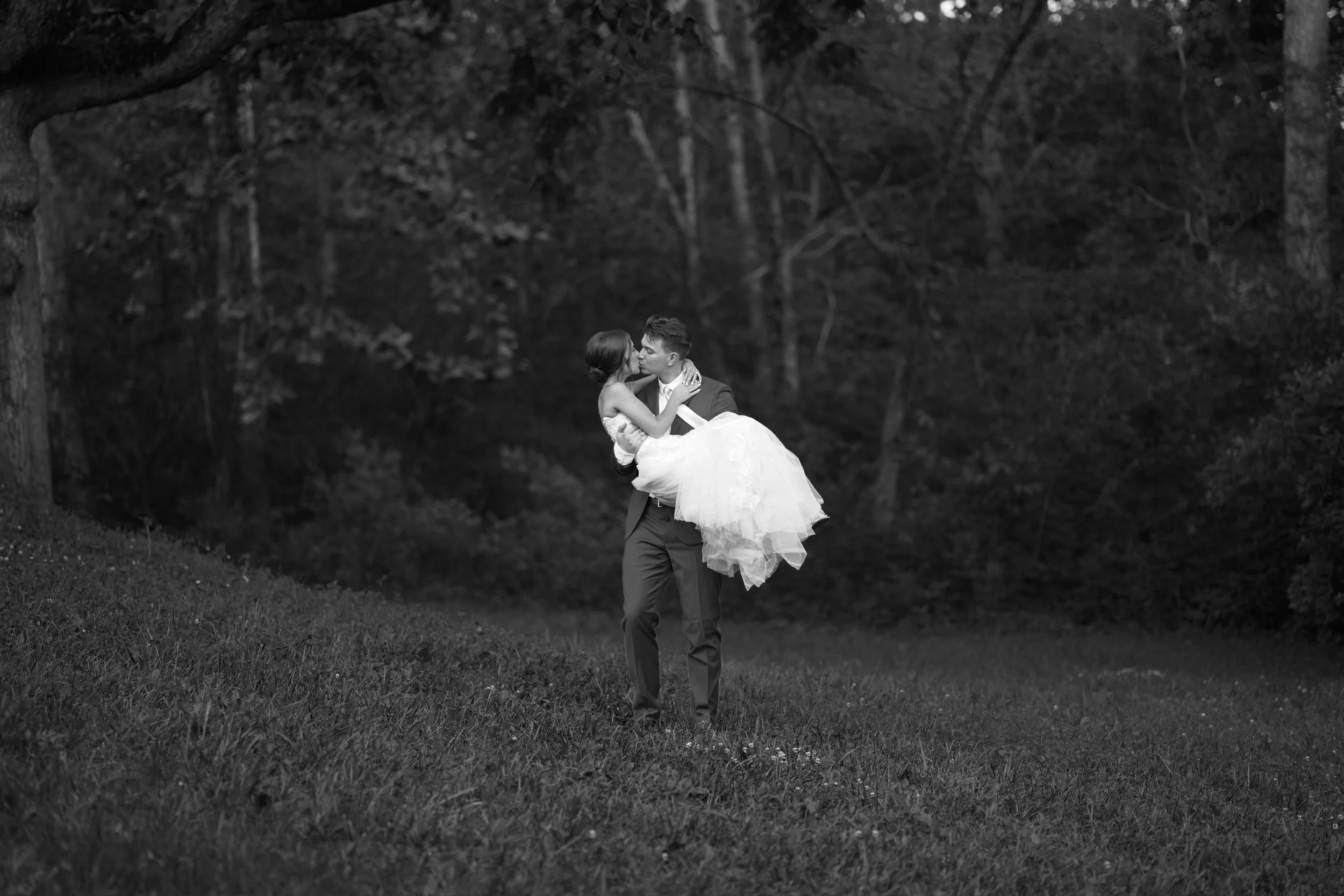 Bride and groom kissing on the forrest