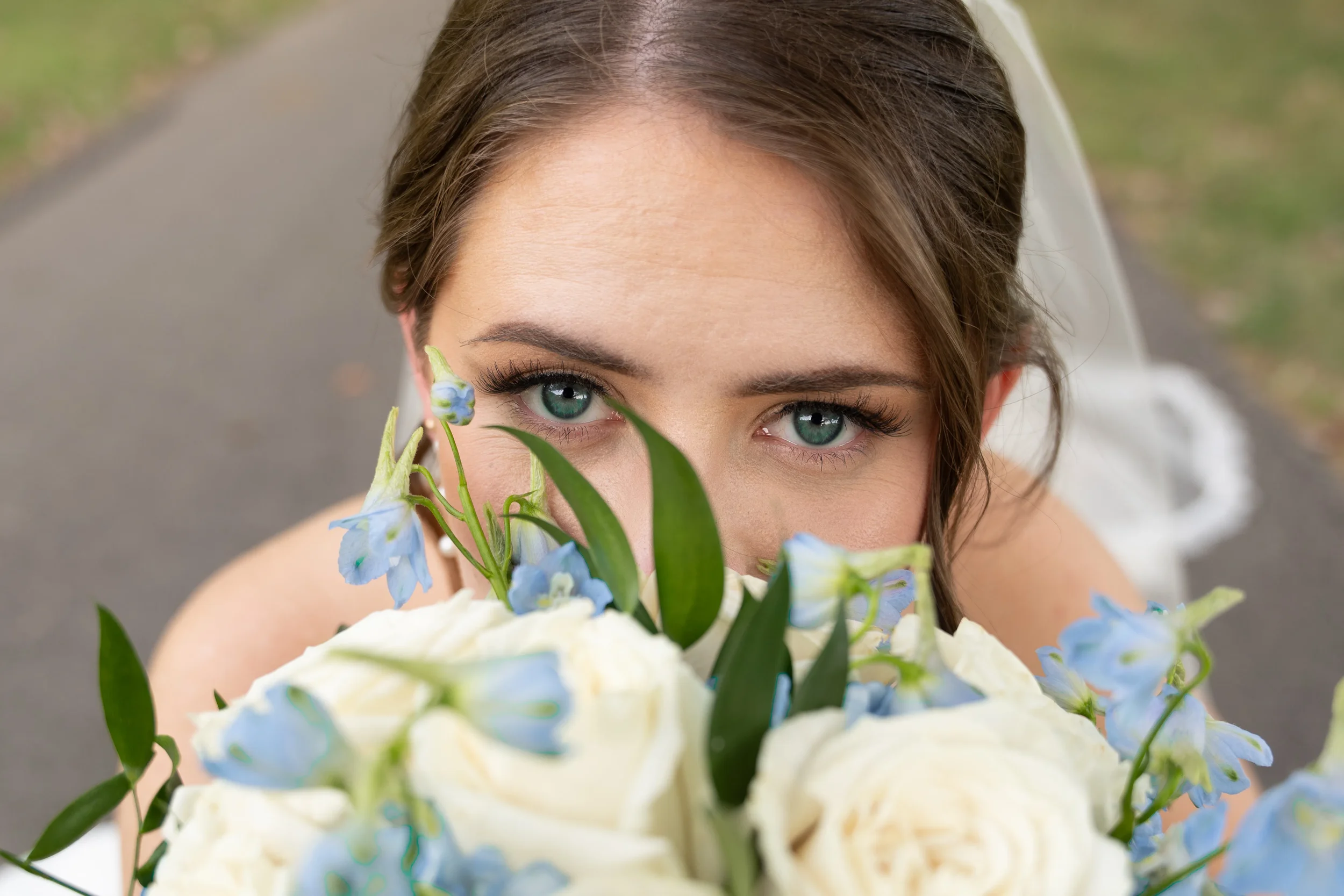 Bride peeking over her flowers