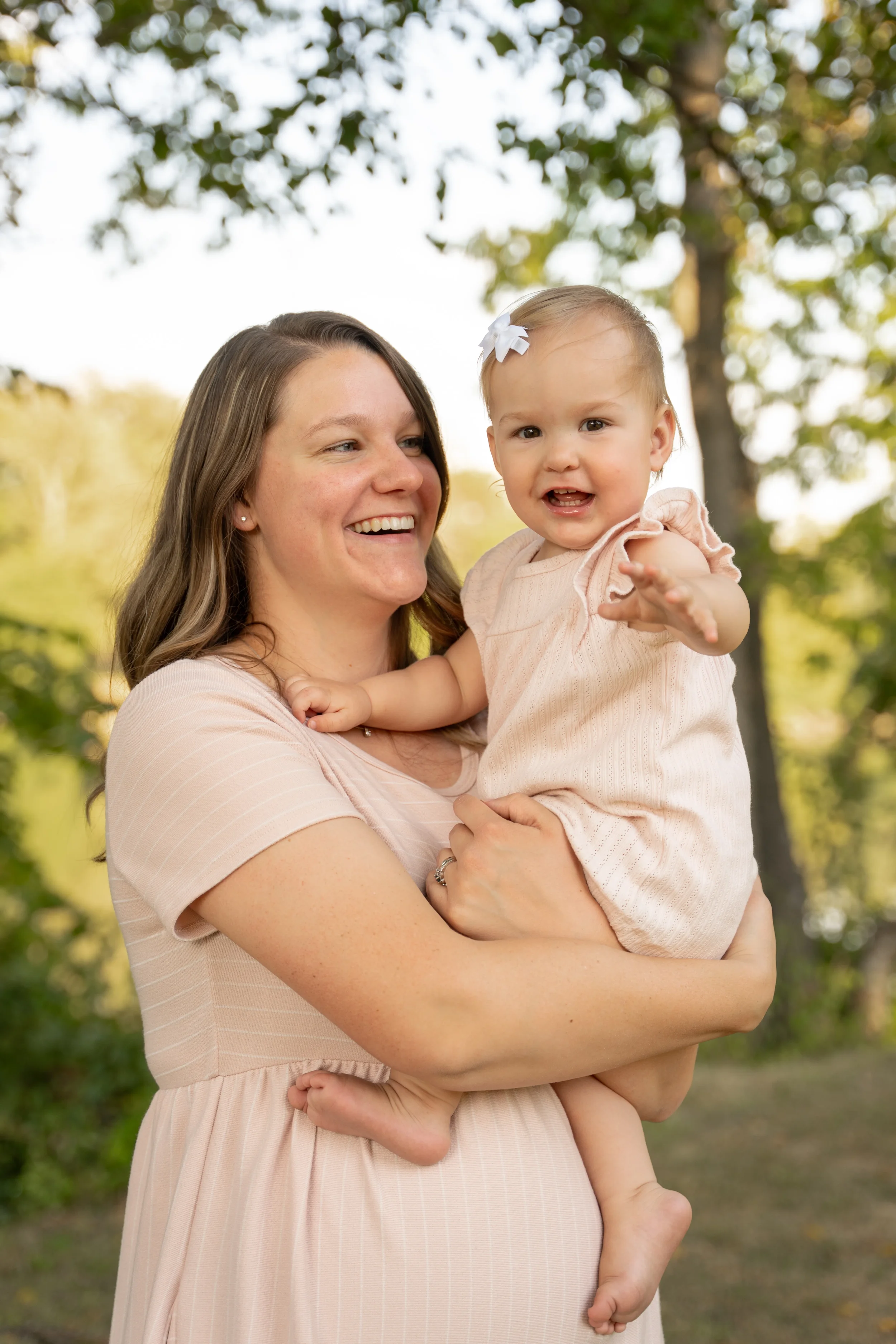 Mother laughing with daughter for photo