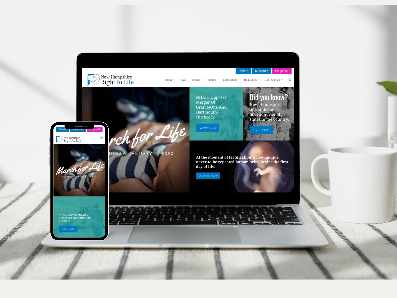 A laptop and a smartphone displaying the 'Right to Life' organization website, placed on a striped fabric surface with a white mug and a clear glass with a plant outside the window in the background.