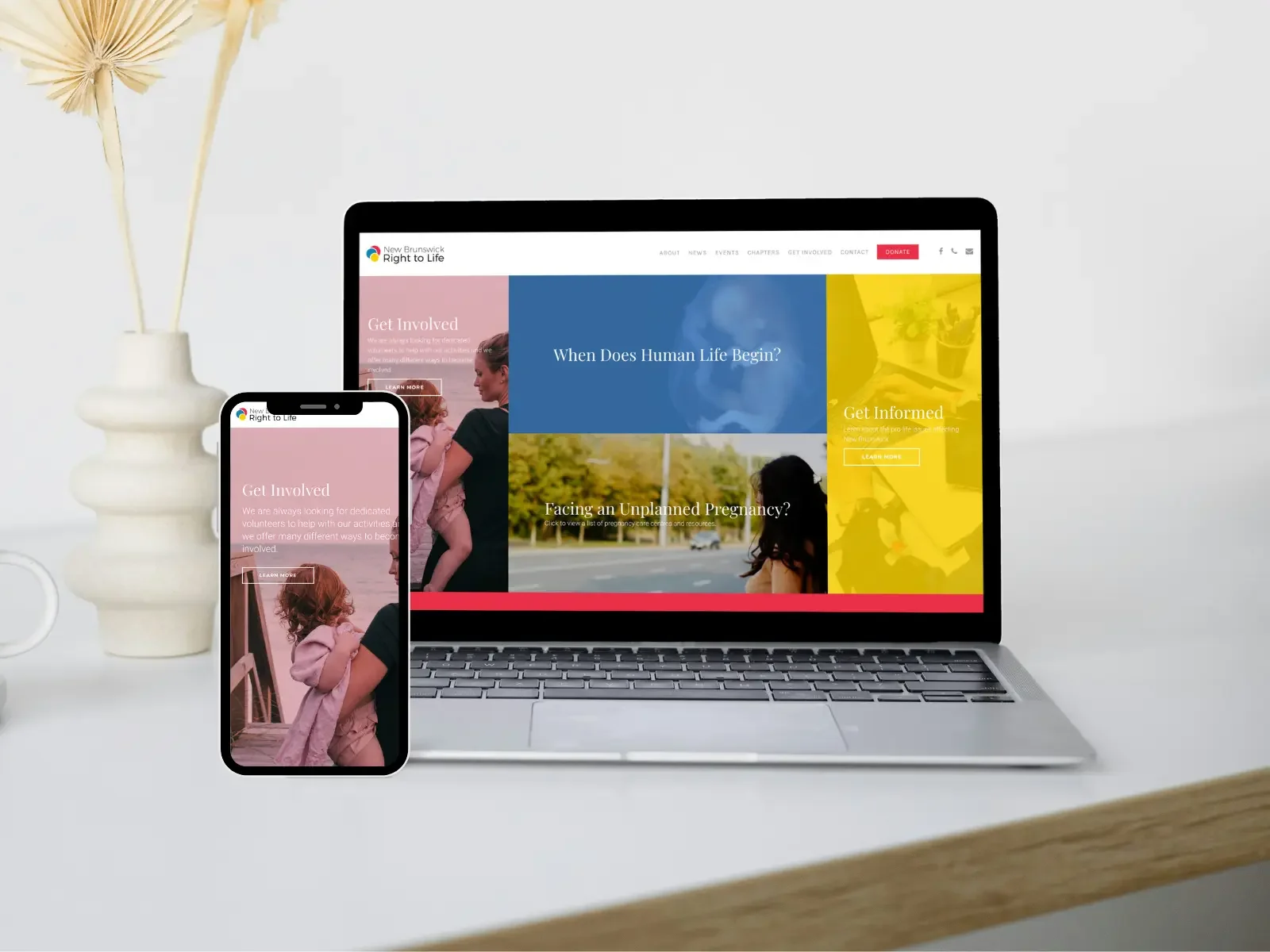 A laptop and smartphone displaying the website Open Tree Creative designed for New Brunswick Right to Life, a nonprofit in New Brunswick, Canada.