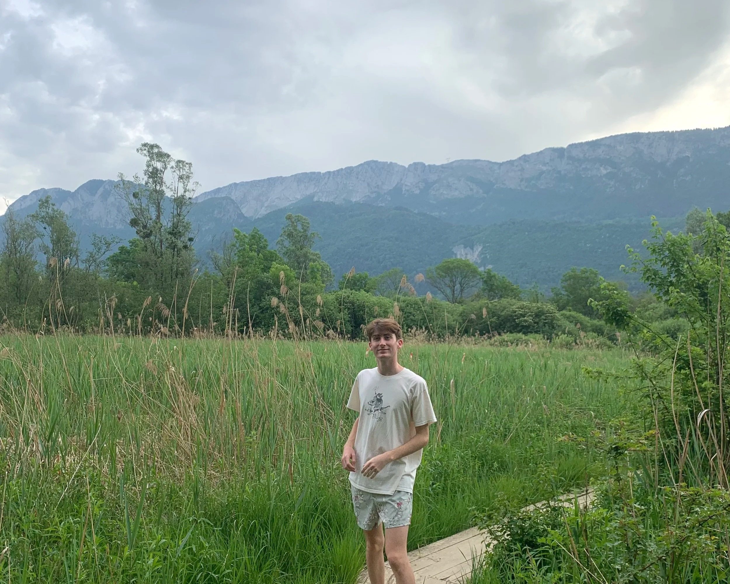 Joseph posing on a hike in Annecy