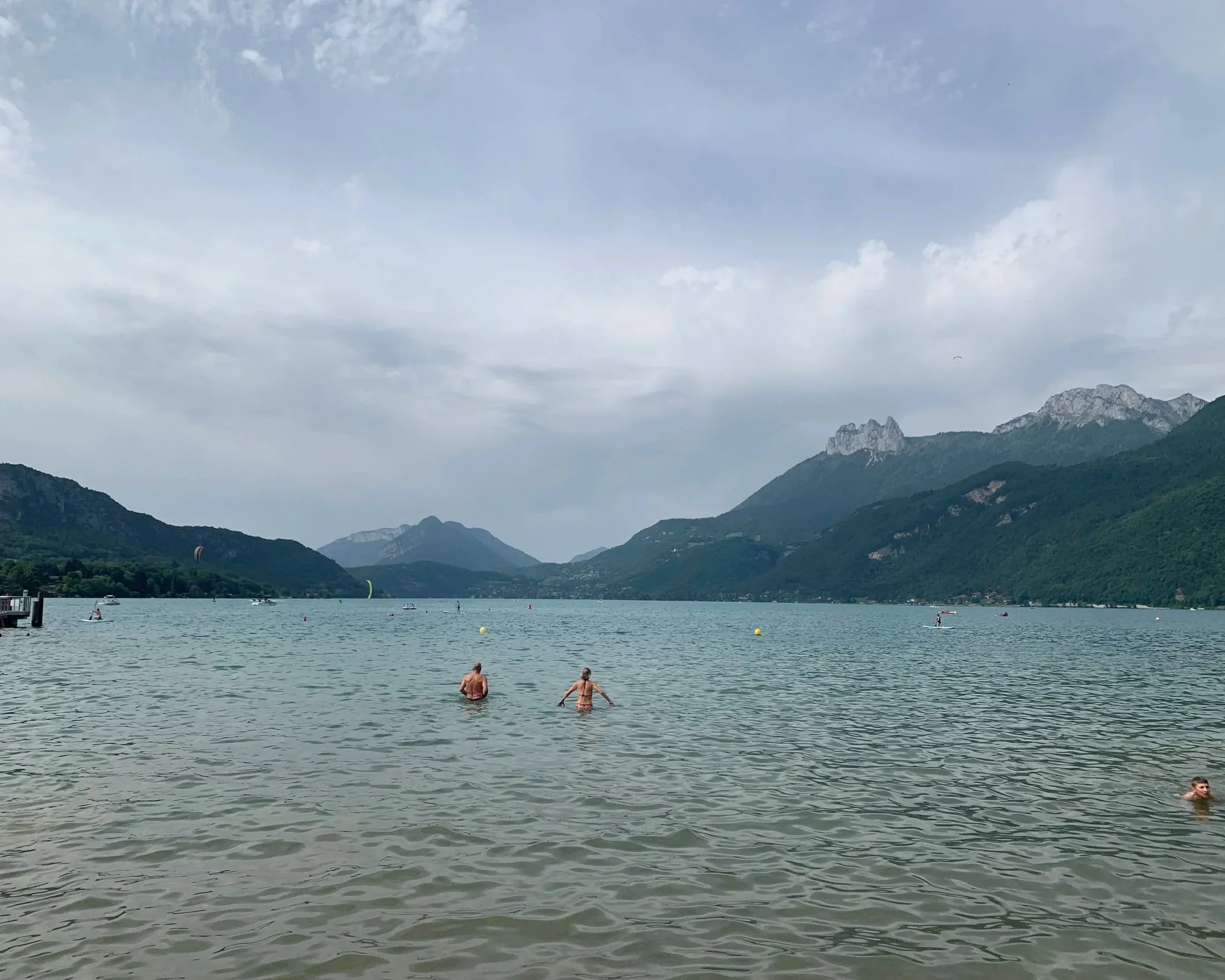 Joseph's family members swimming in Lake Annecy