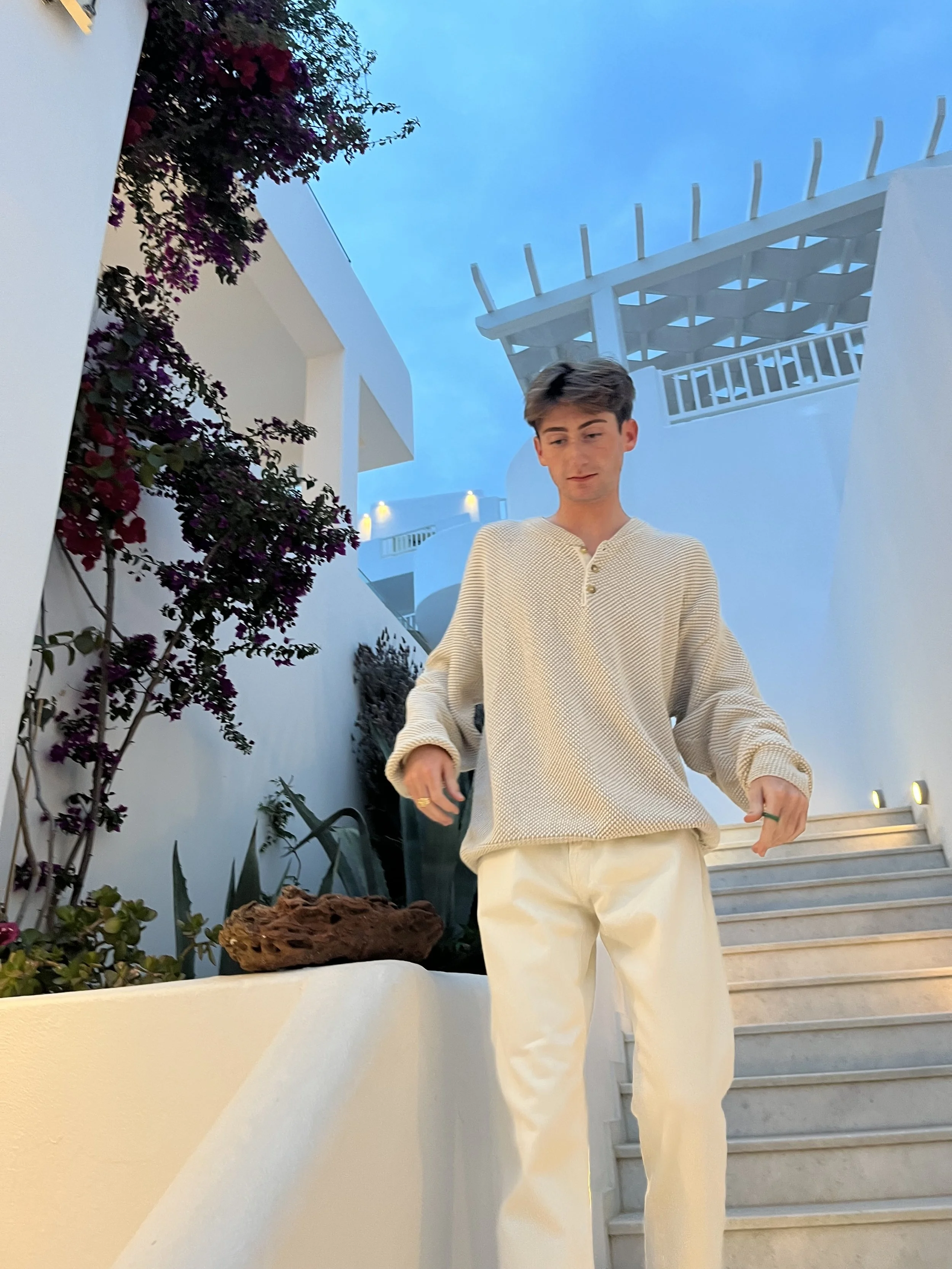 Joseph posing while walking down stairs in Mykonos.