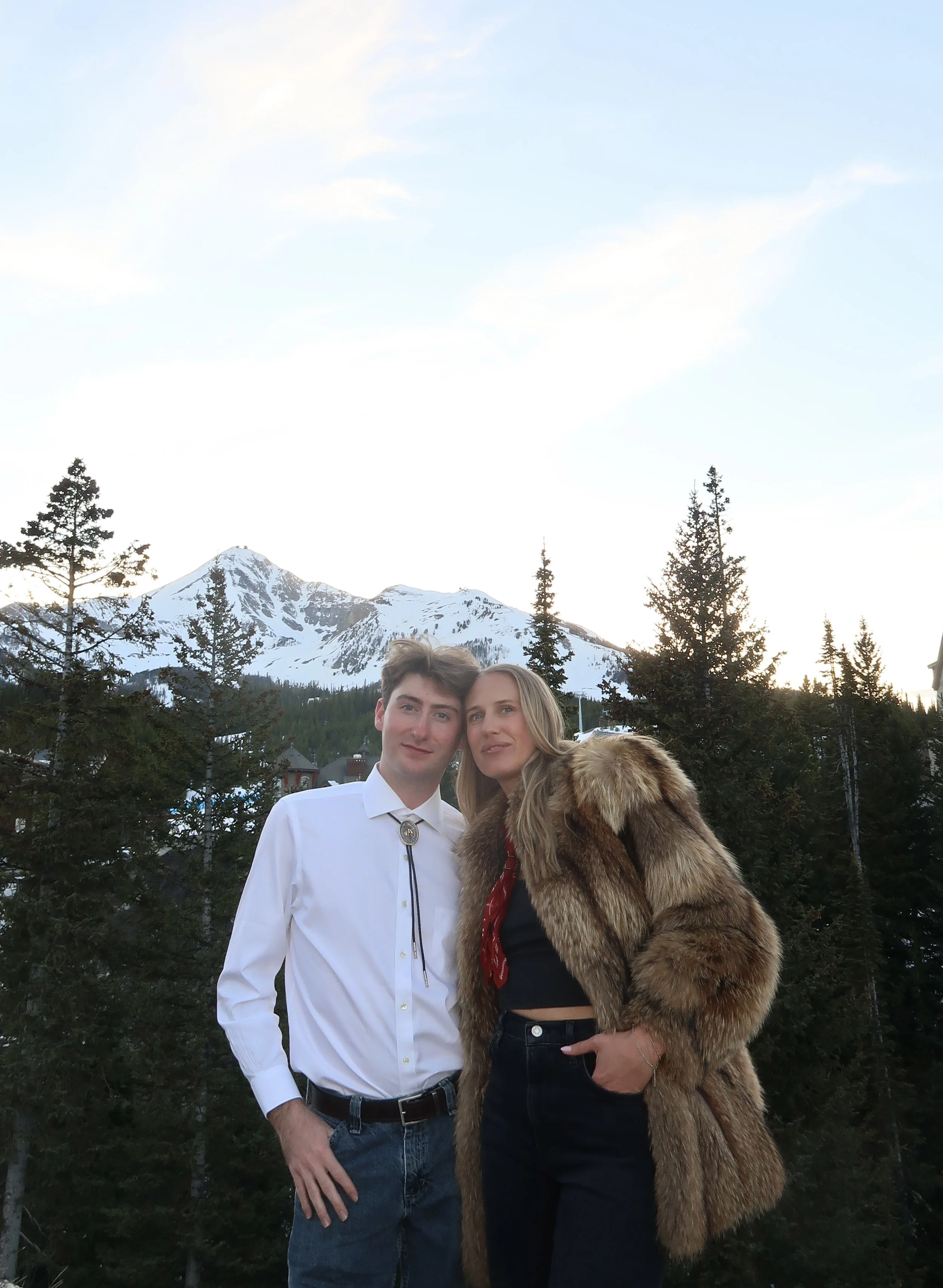 My cousin and I posing in front of scenic mountain views.