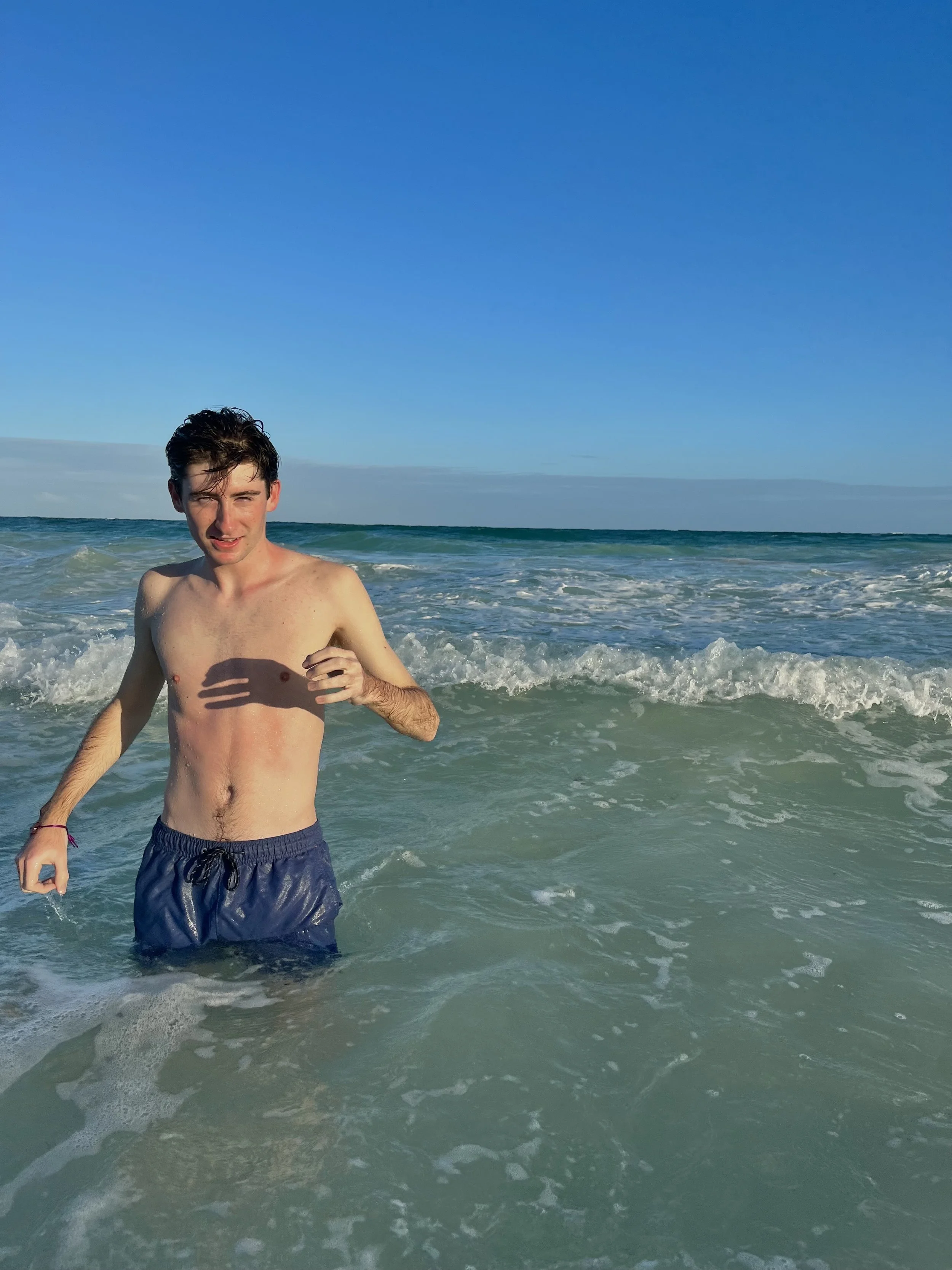 Joseph standing in the beautiful waters on Tulum.