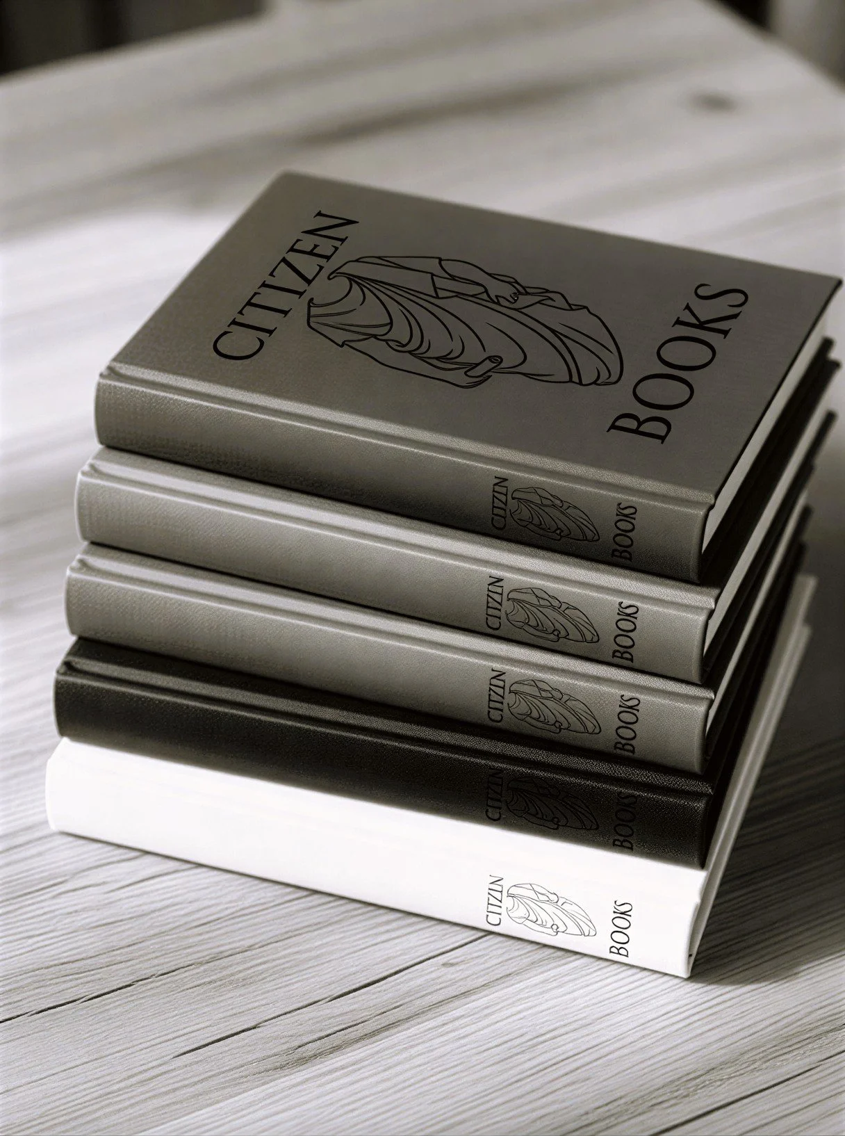 Stack of five Citizen Books with a minimalist logo of a snail on the cover, placed on a light wooden surface.