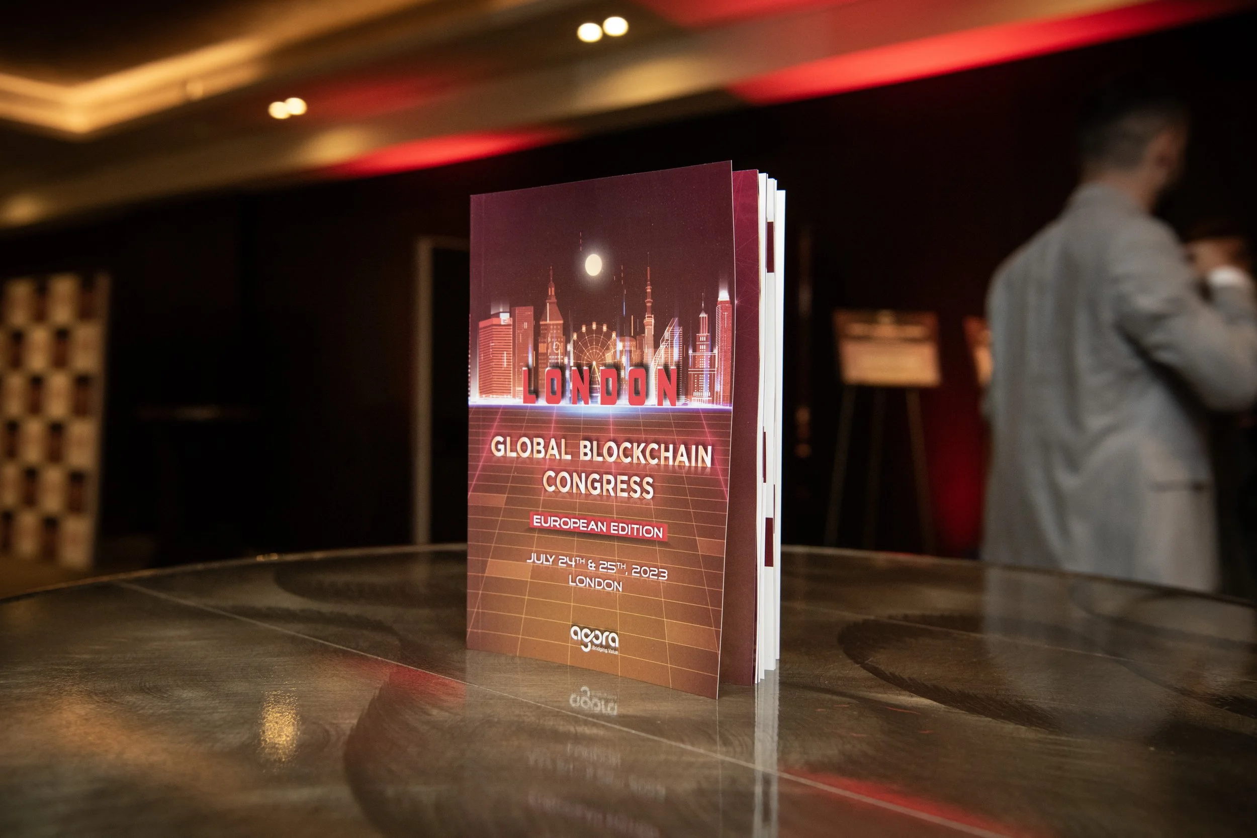 Brochure for the London Global Blockchain Congress, European Edition, held on July 24-25, 2023, featuring a city skyline and a Ferris wheel with a dark background.