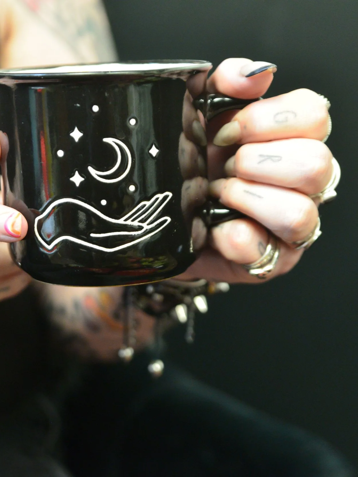 close up image of a person holding a cup of tea